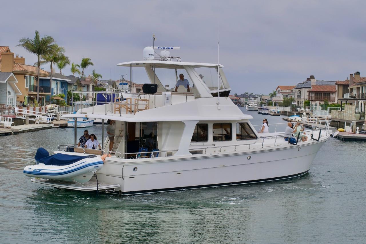 2007 Norseman 560 Sedan yacht cruising in a residential canal.