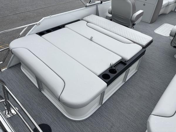 2025 Godfrey SWEETWATER 2286 SFL boat interior with cushioned seating and cup holders.