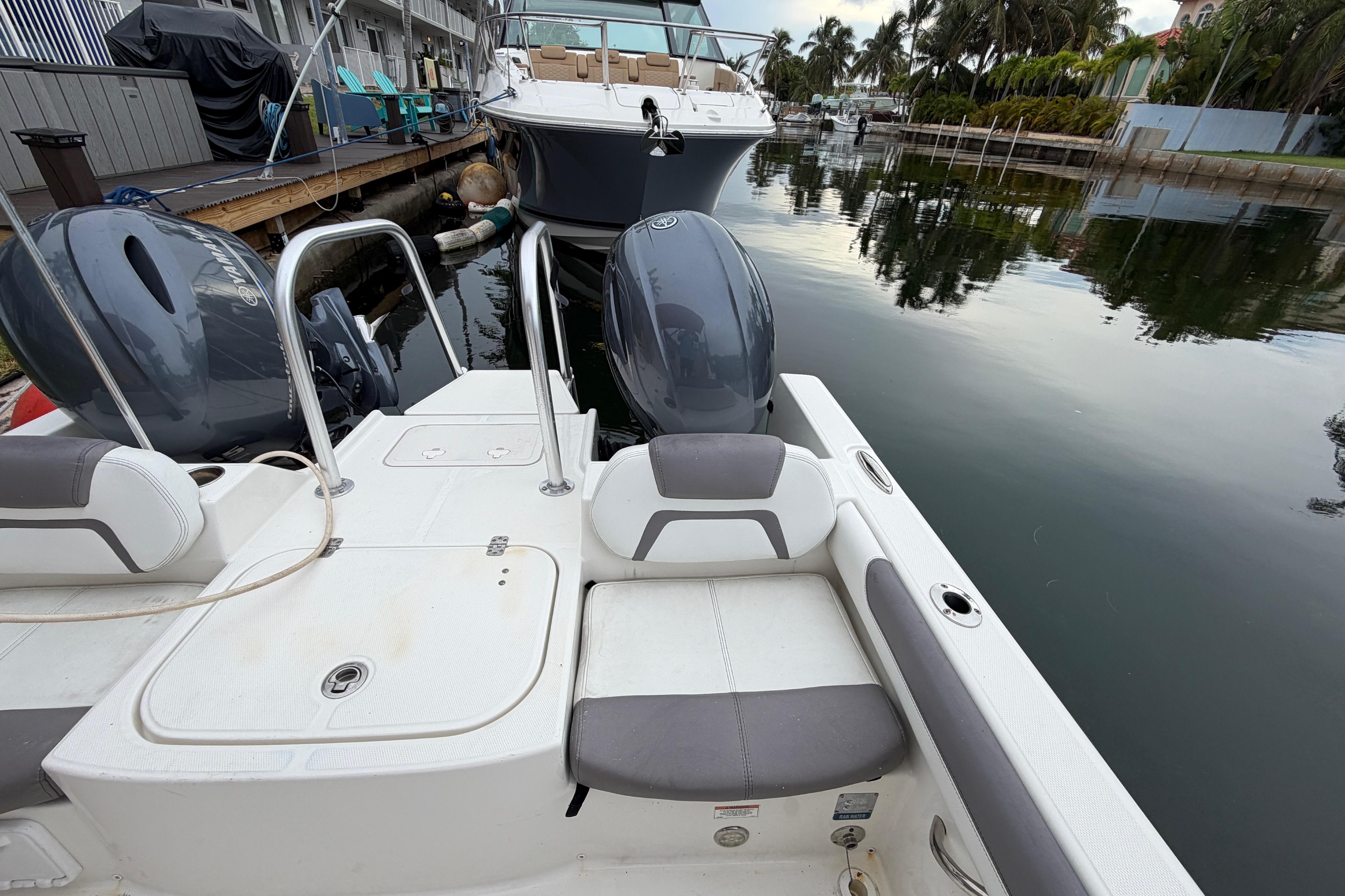 2019 World Cat 230 DC boat docked, featuring dual Yamaha engines and comfortable seating.