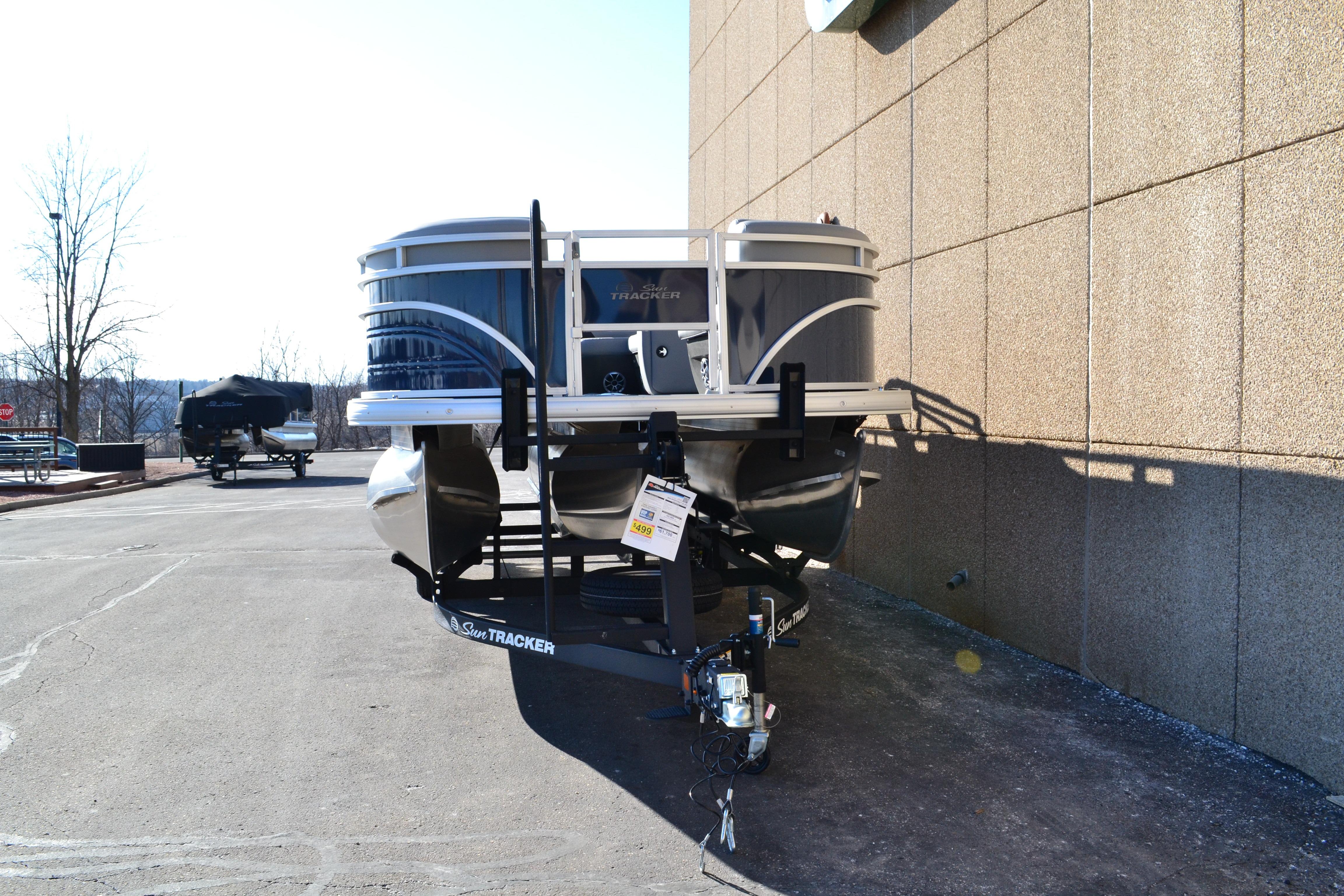 2026 Sun Tracker SportFish 22 XP3 pontoon boat parked outdoors.