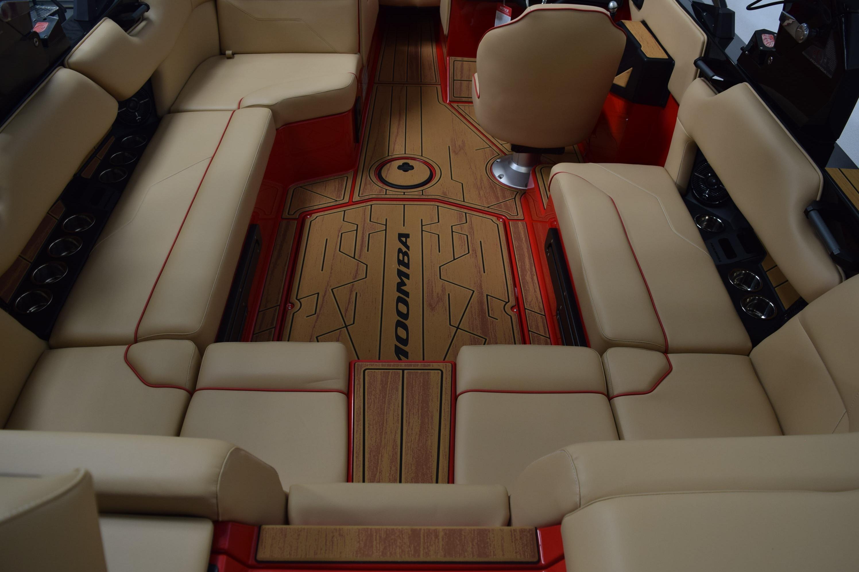 2026 Moomba Max boat interior with beige seating and red accents.