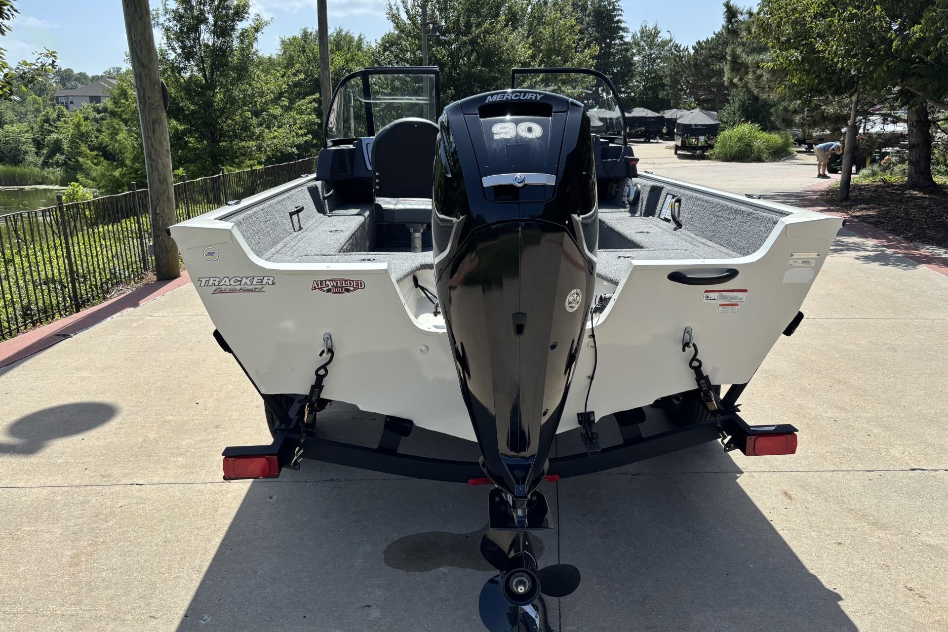 2022 Tracker Pro Guide V-16 SC boat with Mercury 90 engine, parked outdoors.