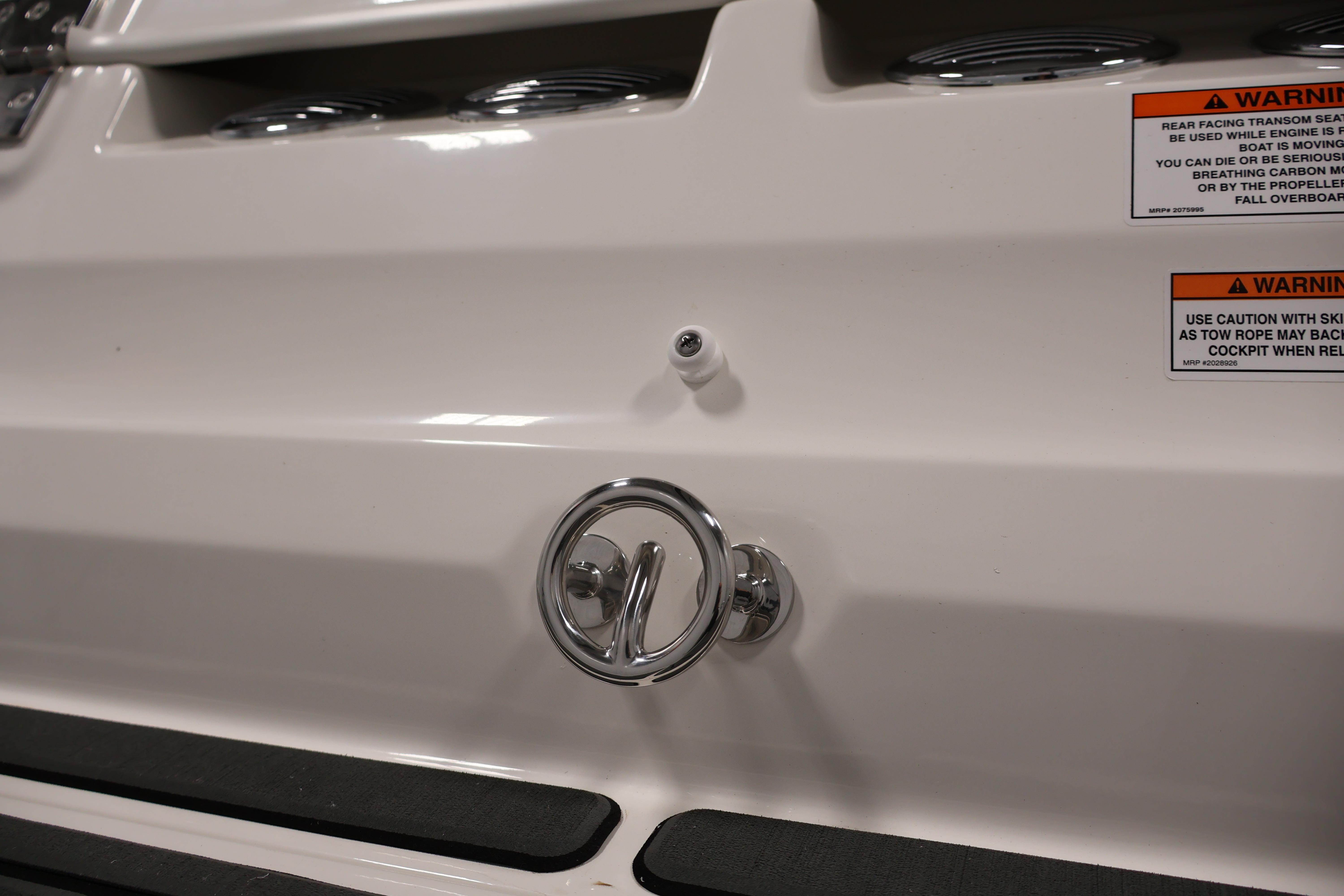 2026 Bayliner VR6 Bowrider I/O boat stern with warning labels and chrome fittings.