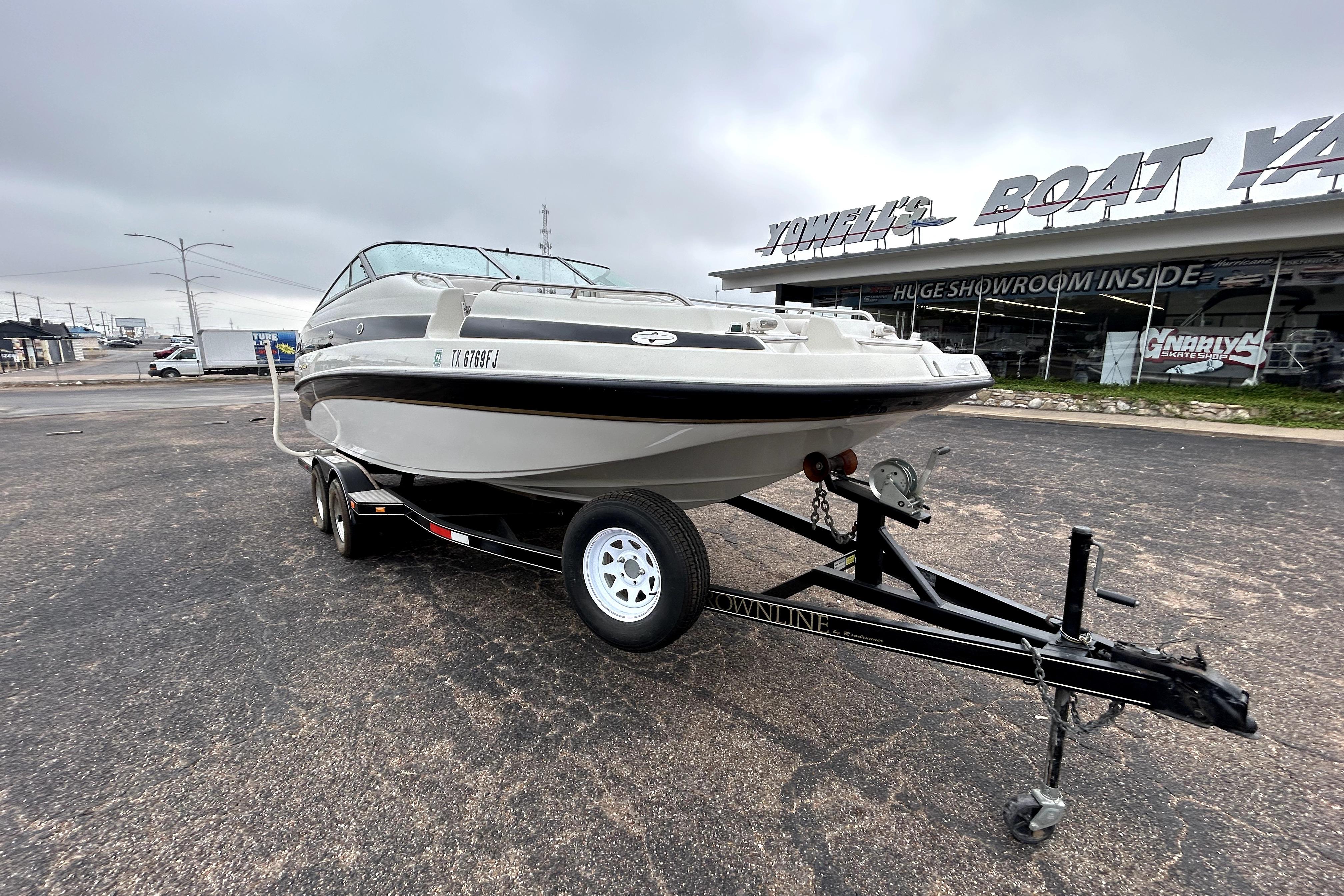 2001 Crownline 239 DB boat on trailer outside Yowell's Boat Yard showroom.