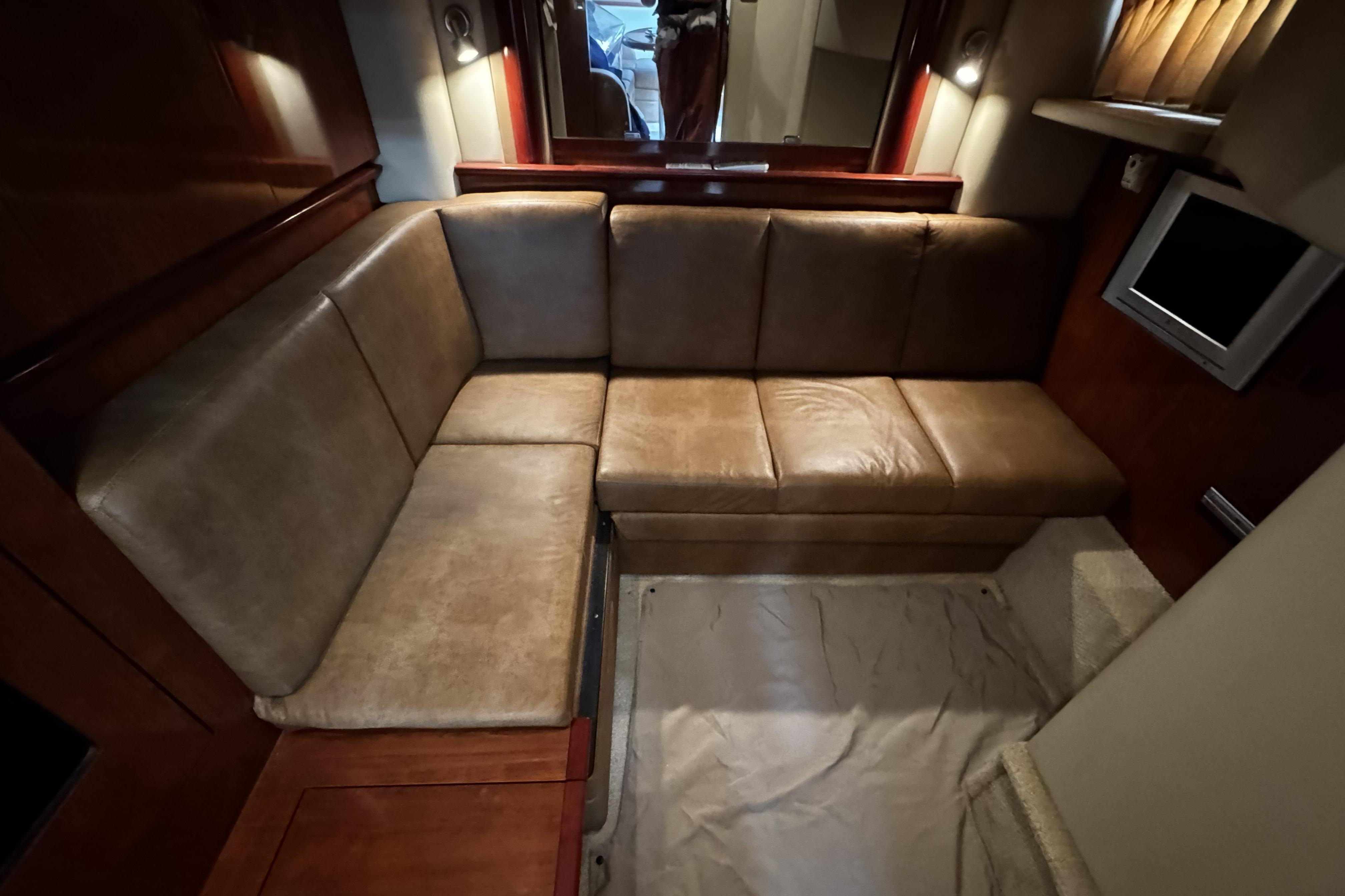 Interior of 2006 Sea Ray 40 Sundancer with brown leather seating and cozy lighting.