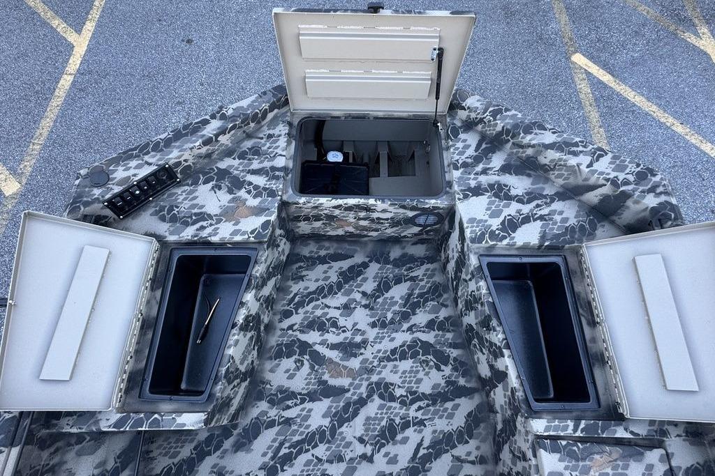 2025 Havoc 1860 boat interior with open storage compartments and camouflage design.