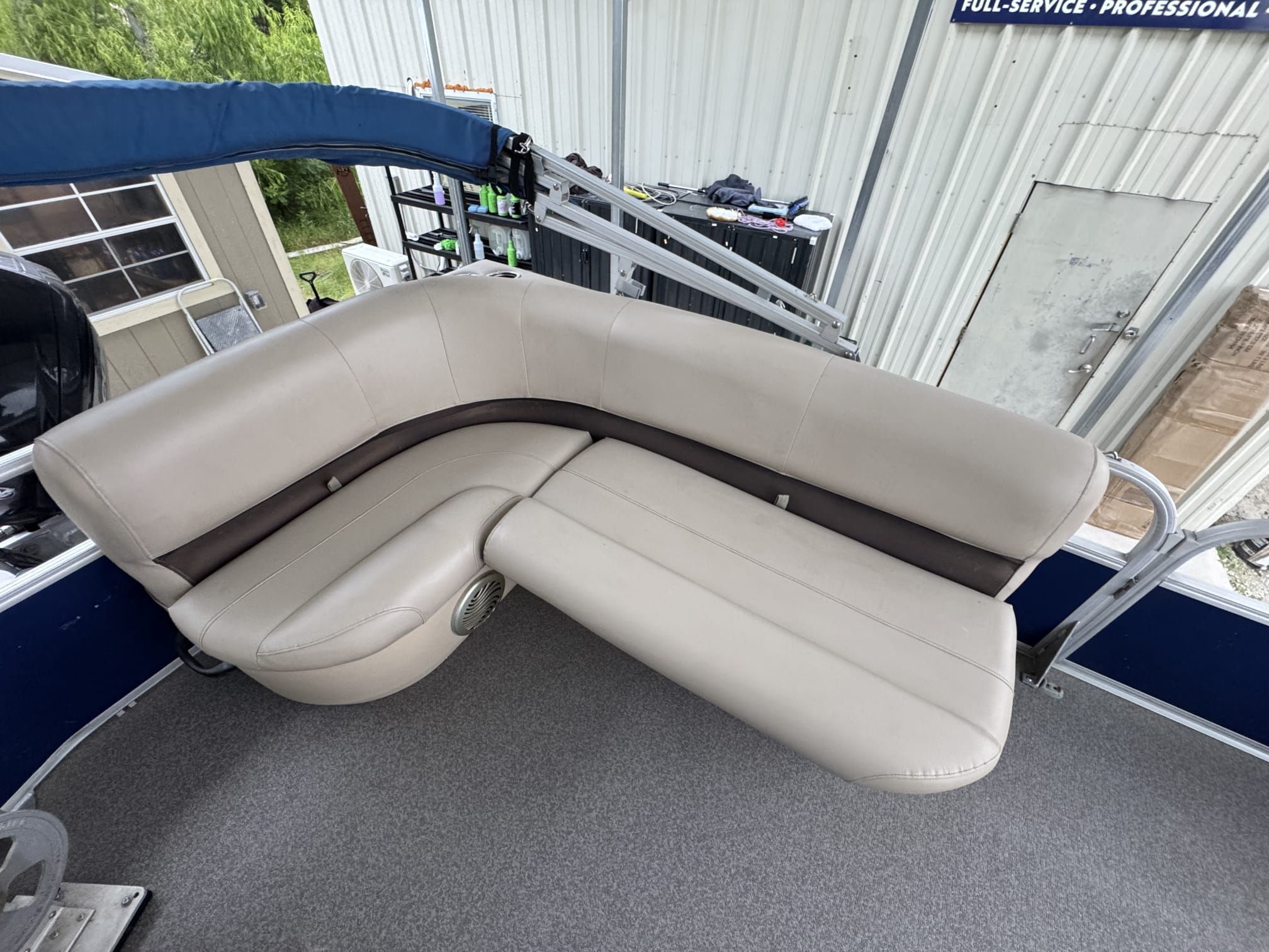 Interior view of a Sun Tracker Party Barge 18 DLX with beige seating area.