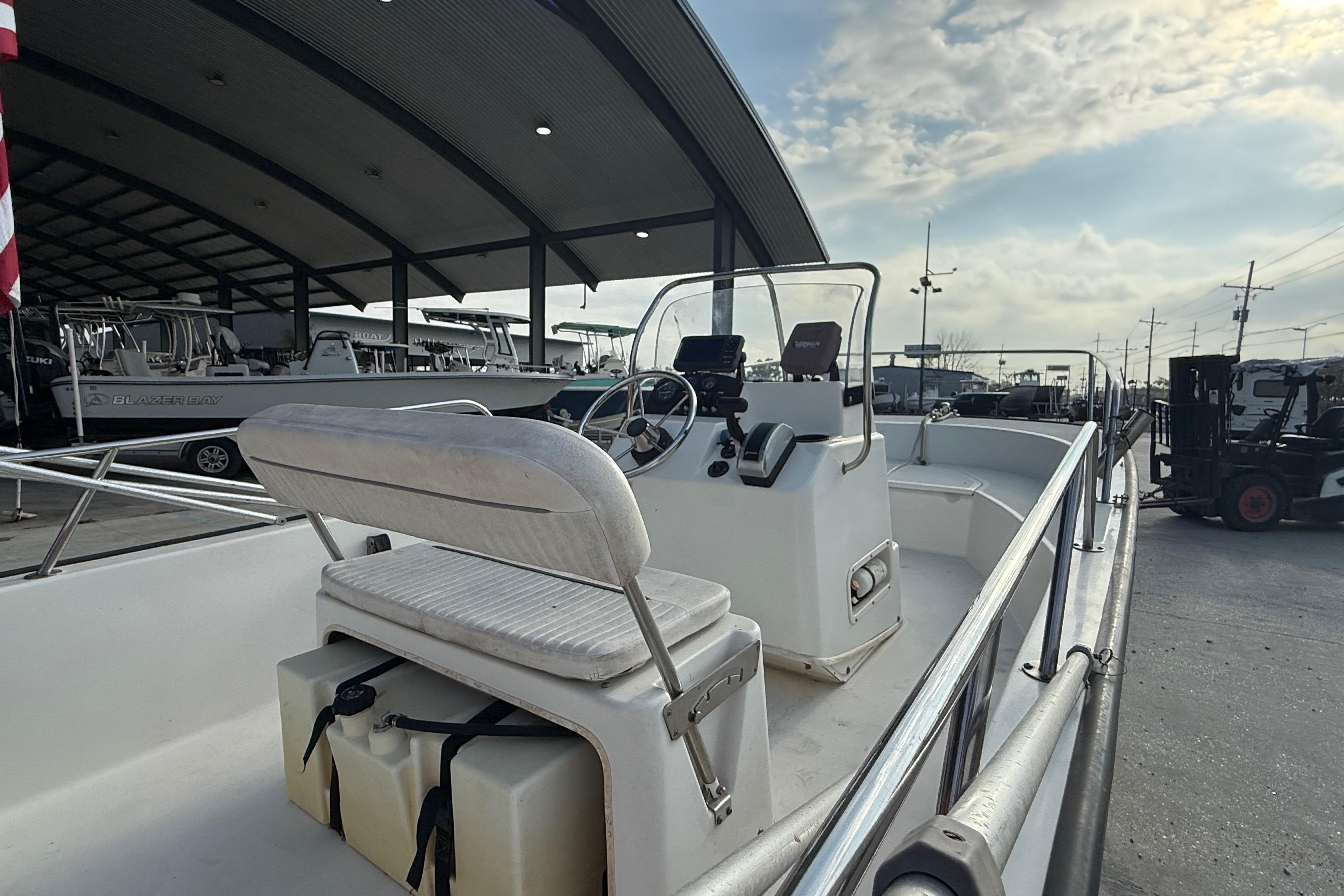 2005 Boston Whaler 17 Montauk boat at marina, featuring console and seating.