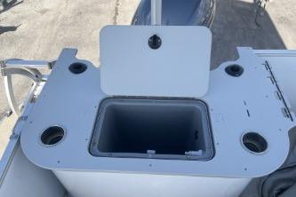 2023 Suntracker G3 Select 322 CC boat console with storage compartment and cup holders.