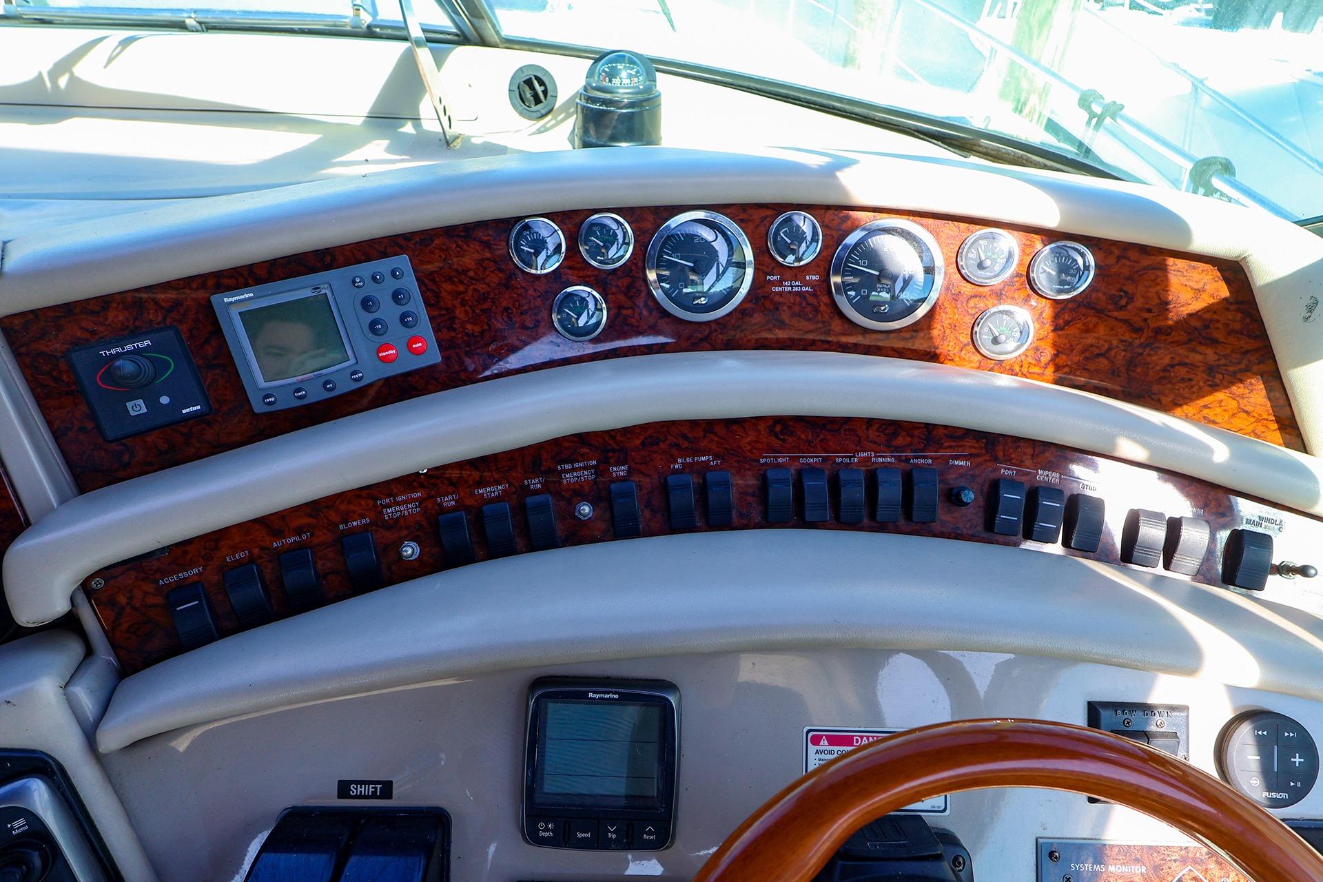 Control panel of a 1998 Sea Ray 500 Sundancer yacht with gauges and switches.