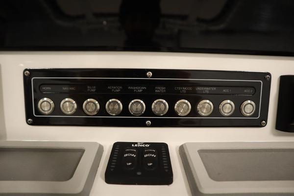 Control panel of 2025 Sea Fox 228 Commander boat with labeled switches and Lenco trim tab controls.