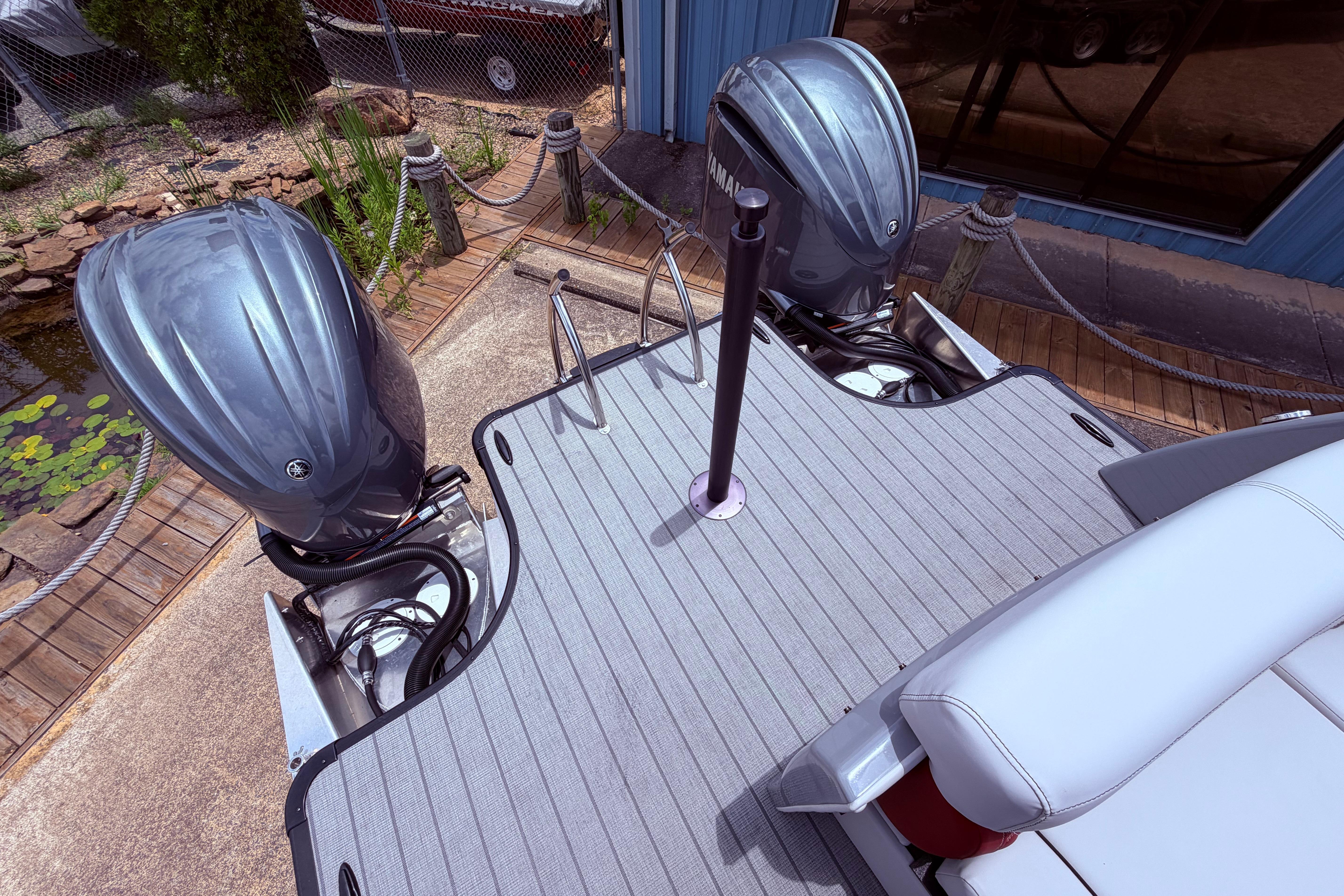 2023 Godfrey Sanpan 2700 ULW Twin boat with dual outboard motors, docked on a sunny day.