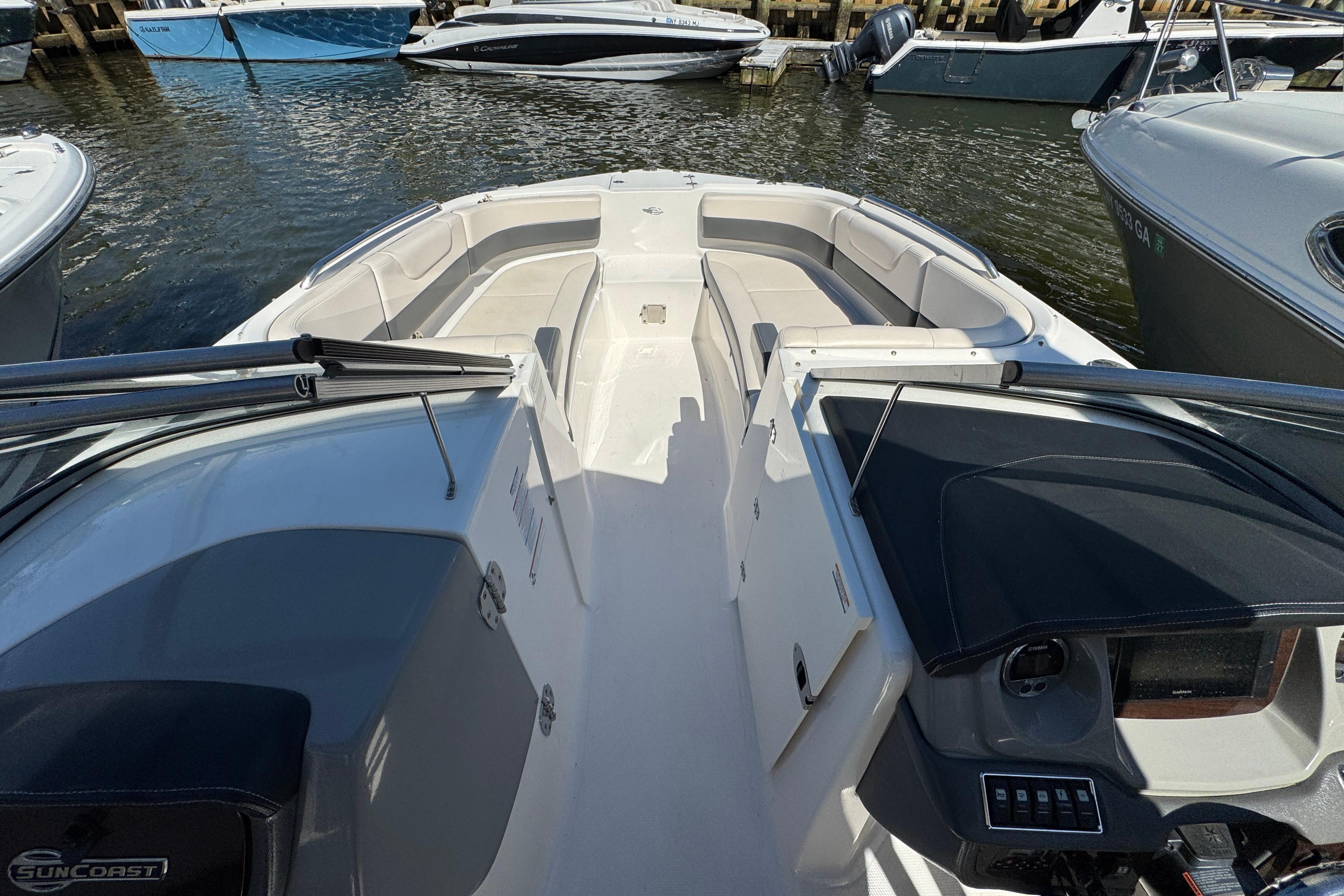 2018 Chaparral 250 Suncoast boat interior, featuring spacious seating and modern dashboard controls.