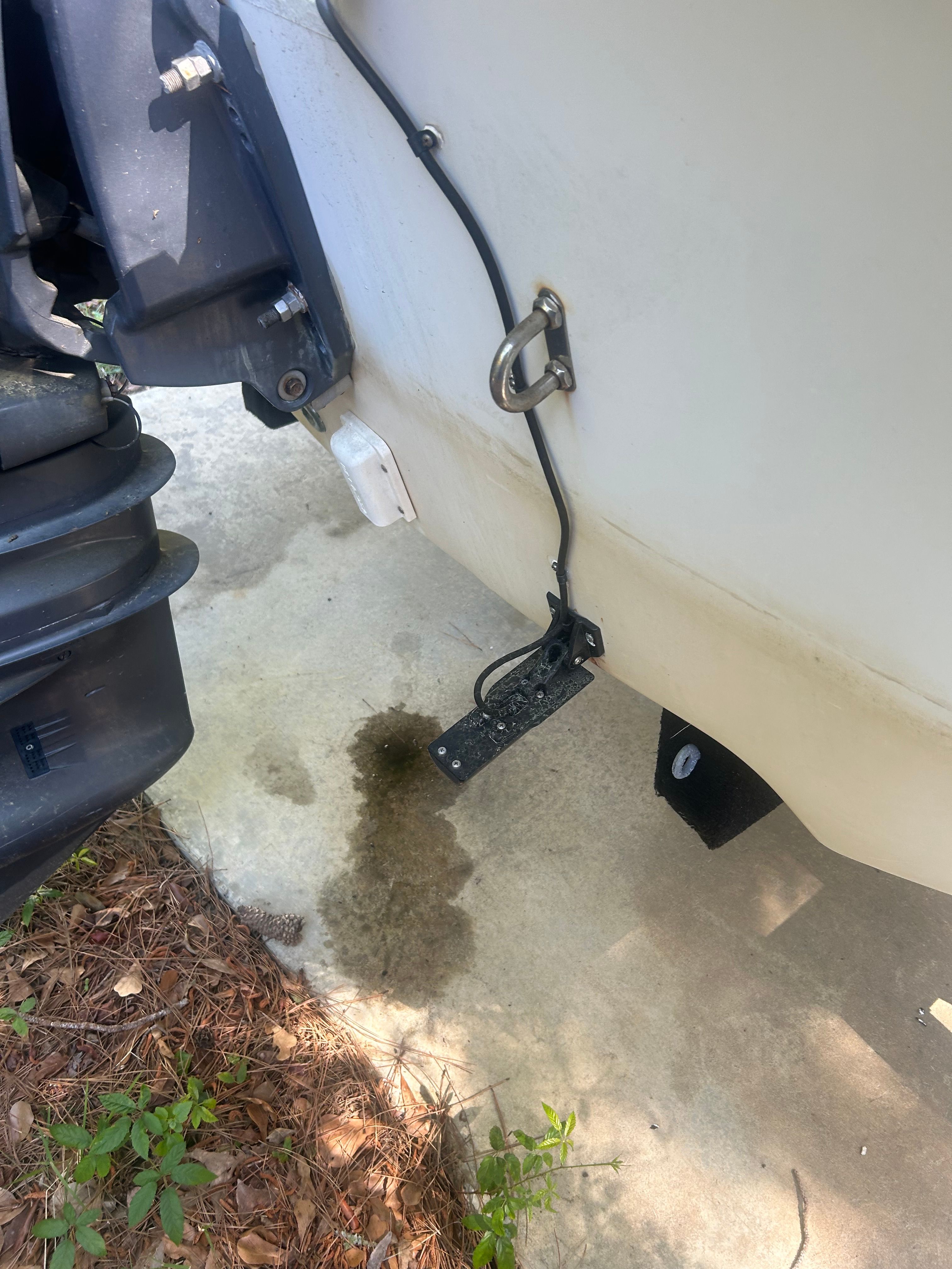 Rear view of a 2011 Carolina Skiff 258 DLV boat with motor.