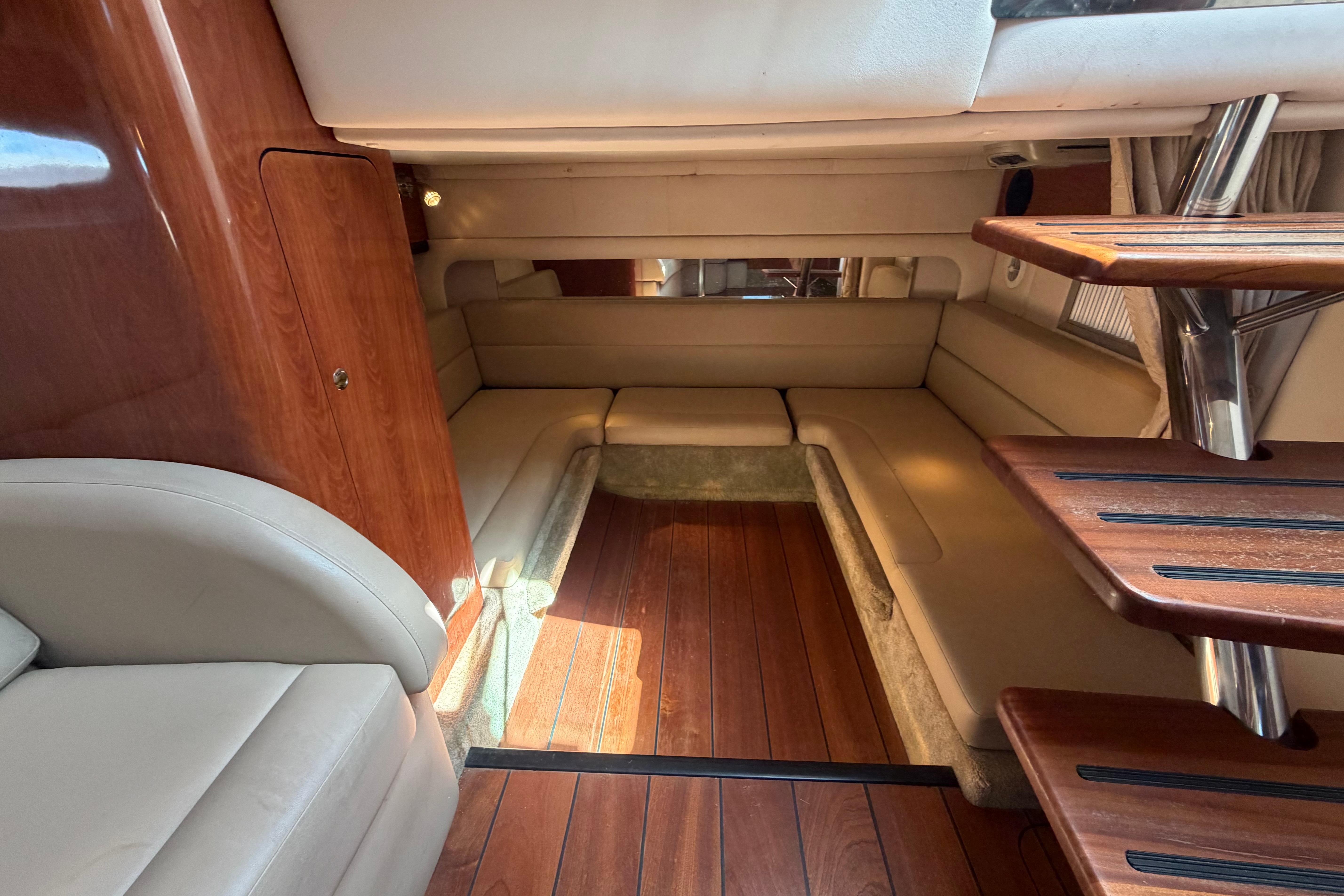 Interior of 2008 Crownline 340 CR boat with wood flooring and beige seating.