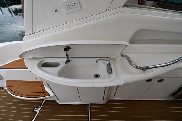 2003 Sea Ray 460 Sundancer yacht sink area with wooden deck flooring.