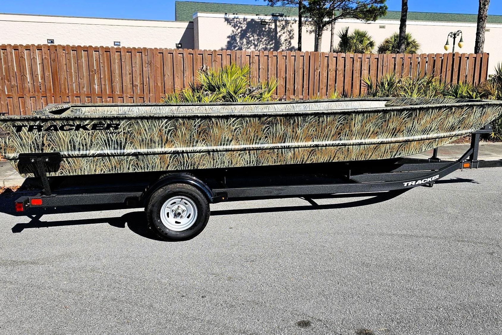 2026 Tracker Grizzly 2072 Utility boat with camouflage design on a trailer.