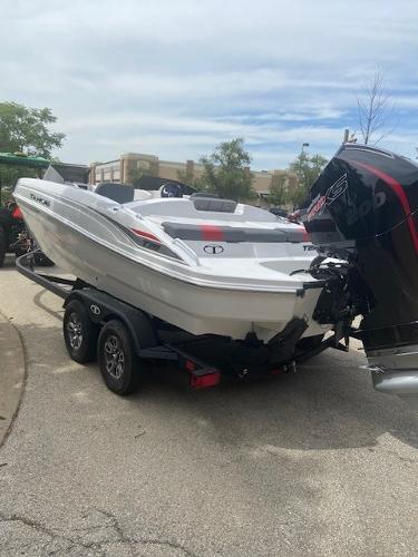 2025 Tahoe T21 boat on trailer, parked outdoors.