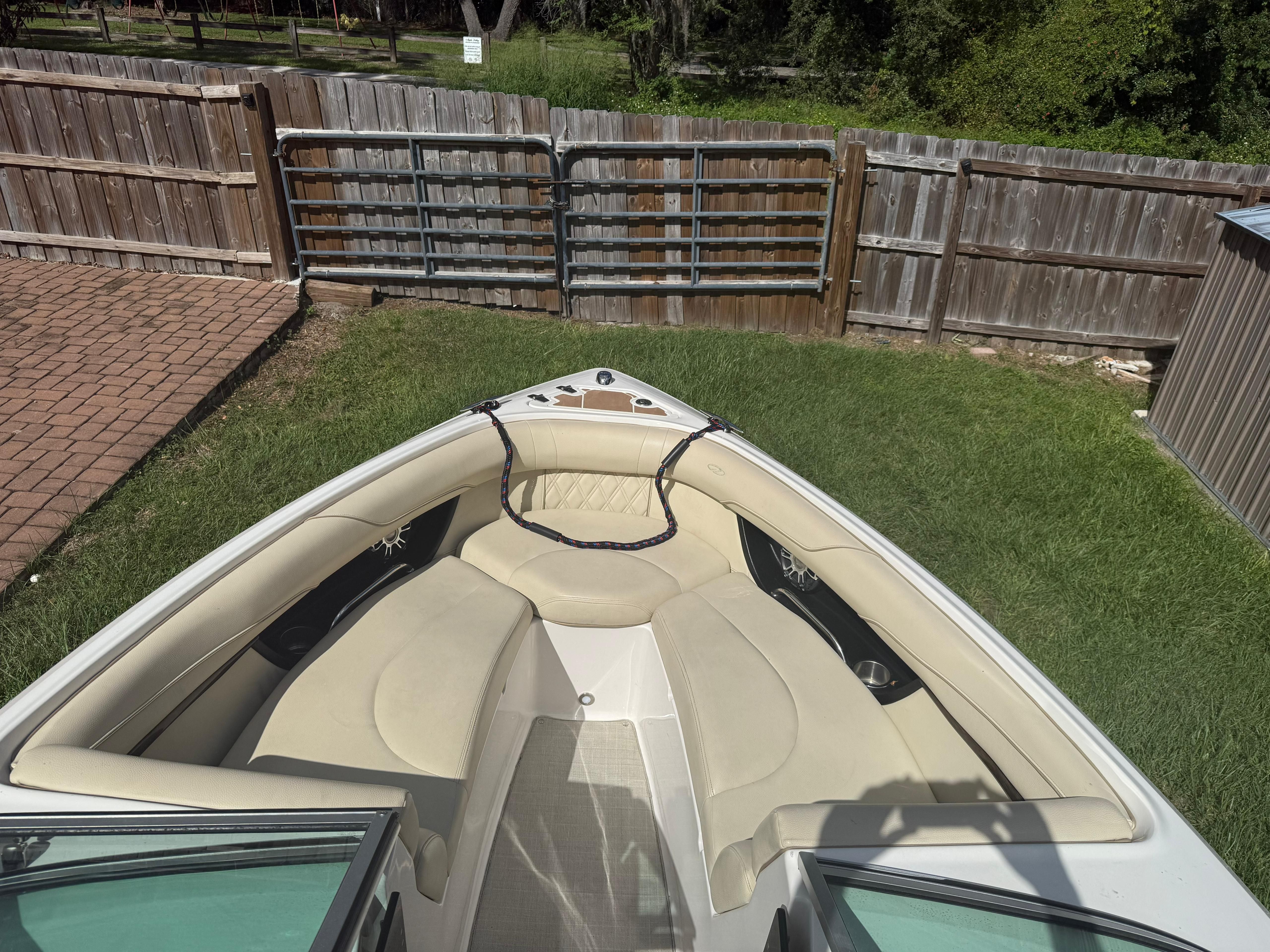 2020 Regal 2300 Bowrider with beige interior, parked in a garden.