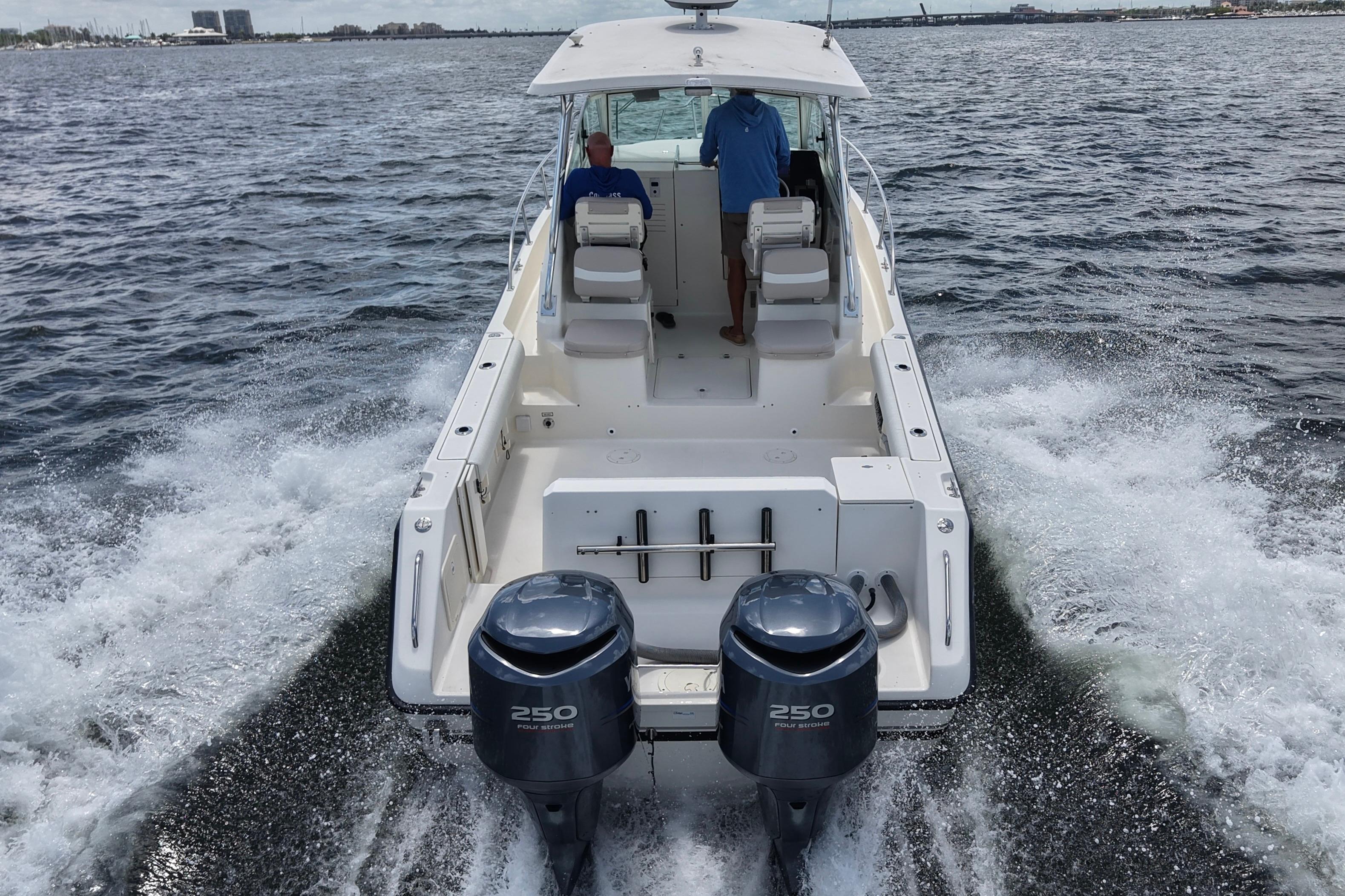 2004 Pursuit 2870 Walkaround boat cruising on open water with dual engines.