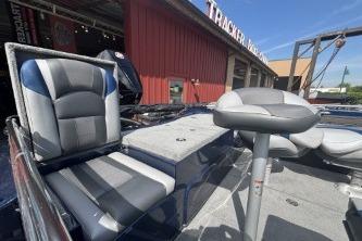2026 Nitro ZV19 Sport Pro boat with gray seats in front of Tracker building.