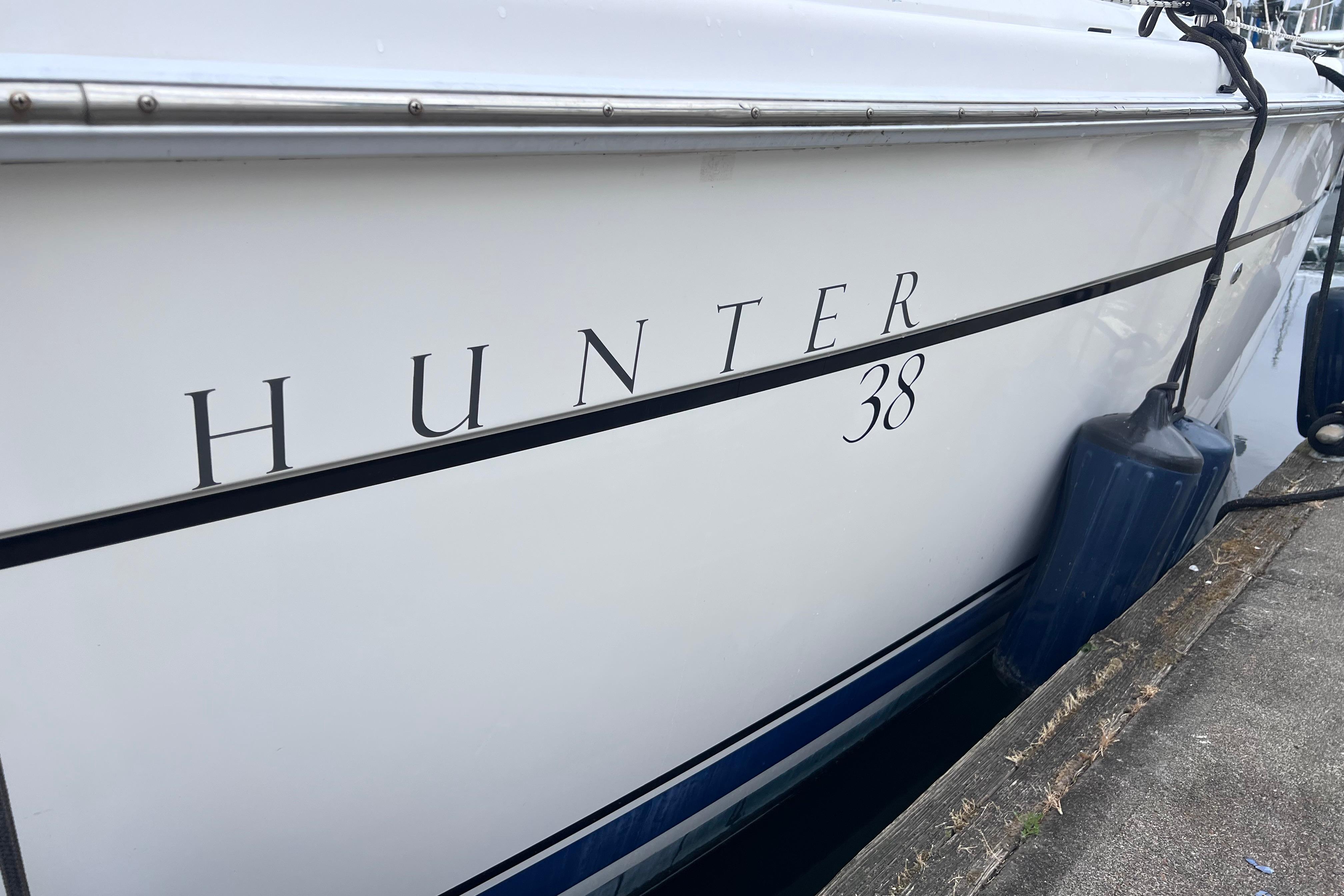 Side view of a 2006 Hunter 38 yacht docked.