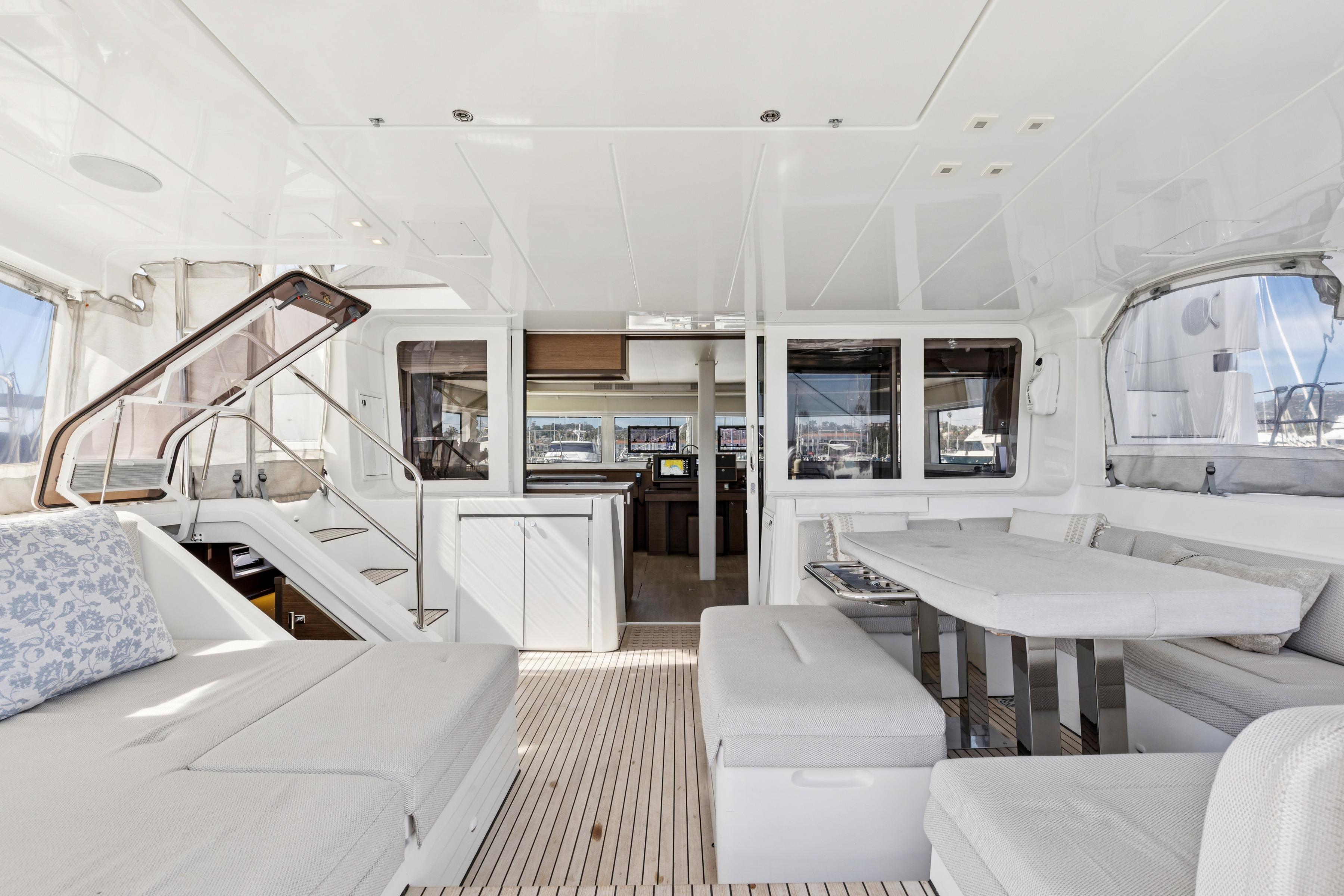 Luxurious interior of 2022 Lagoon 52 F catamaran with modern seating and dining area.