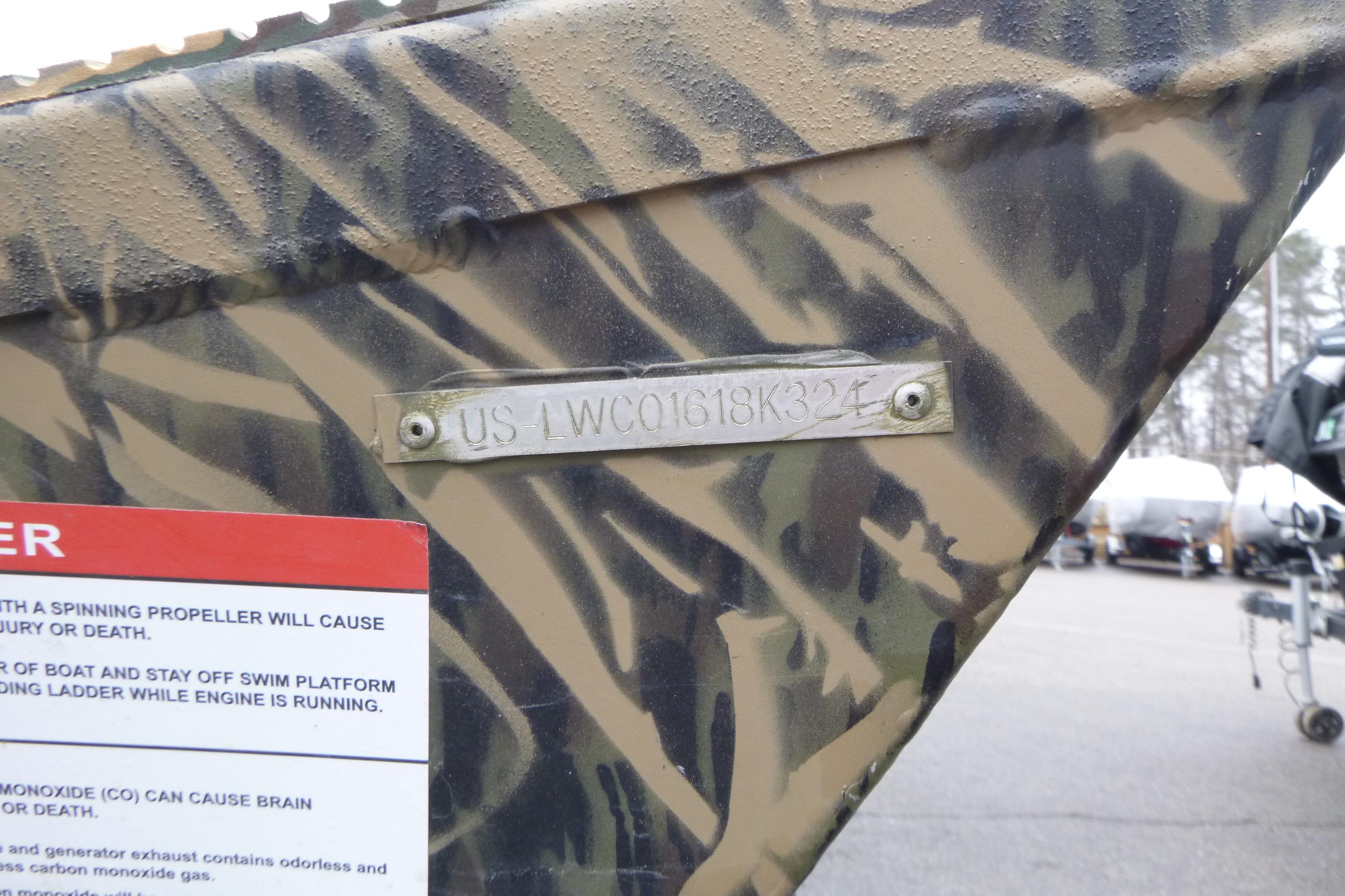 2024 Lowe Roughneck 2070 boat with camouflage pattern and identification plate.