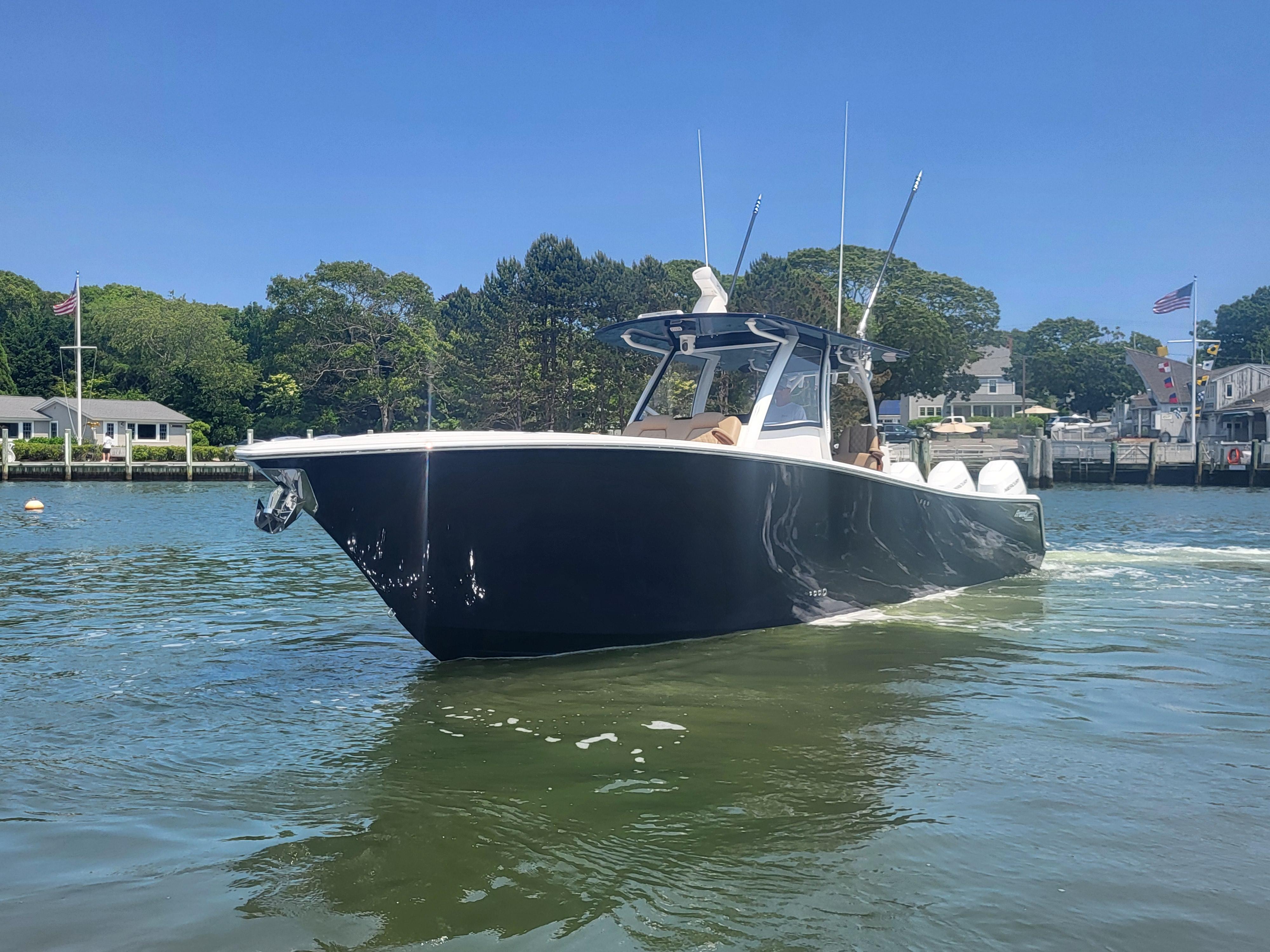 2025 Front Runner 39 boat cruising on a sunny day in a scenic harbor.