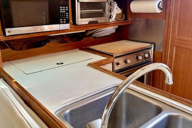 1992 Catalina 34 yacht kitchen with sink, stove, and microwave.