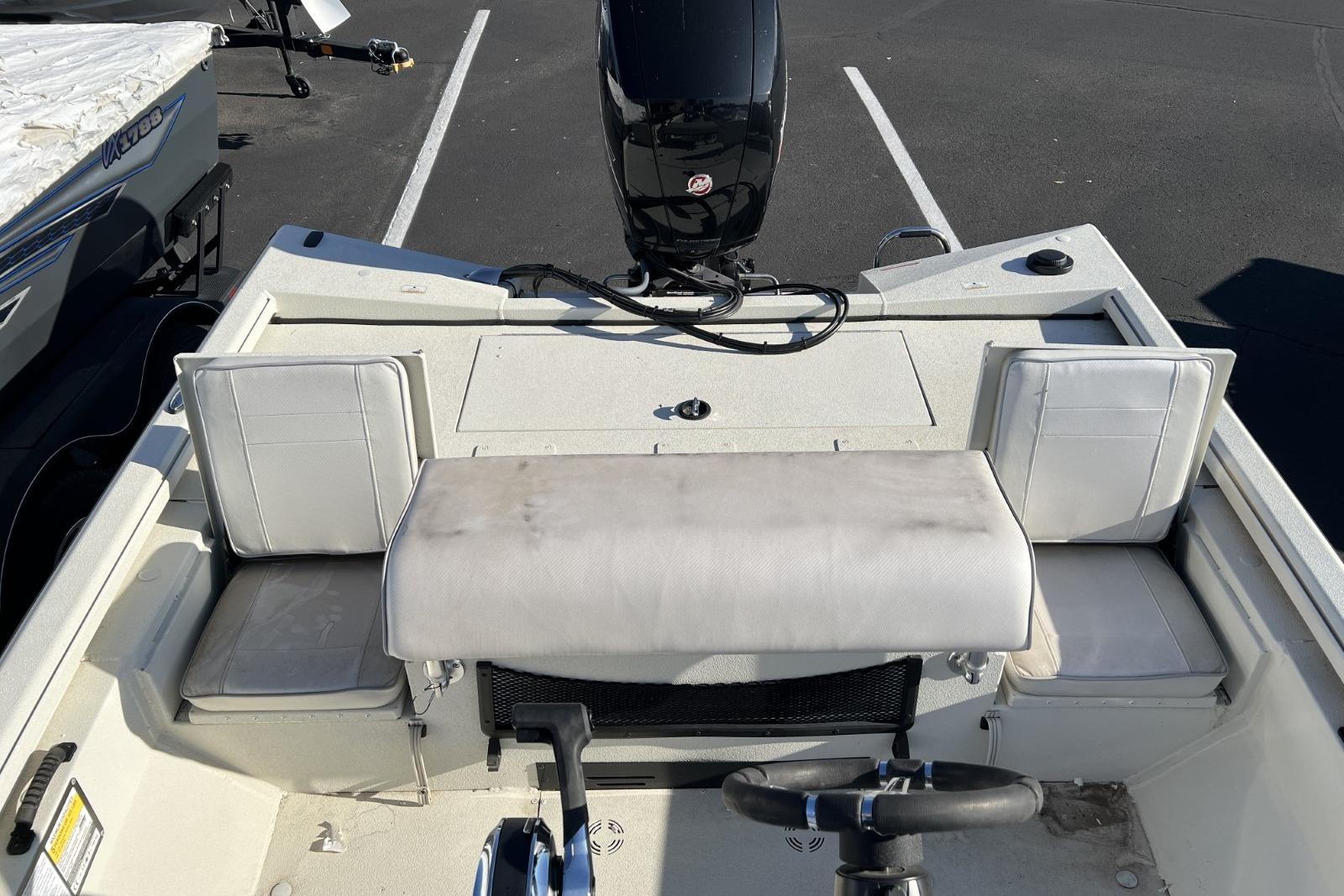 2024 Ranger RB200 boat interior with seating and steering wheel in a parking lot.