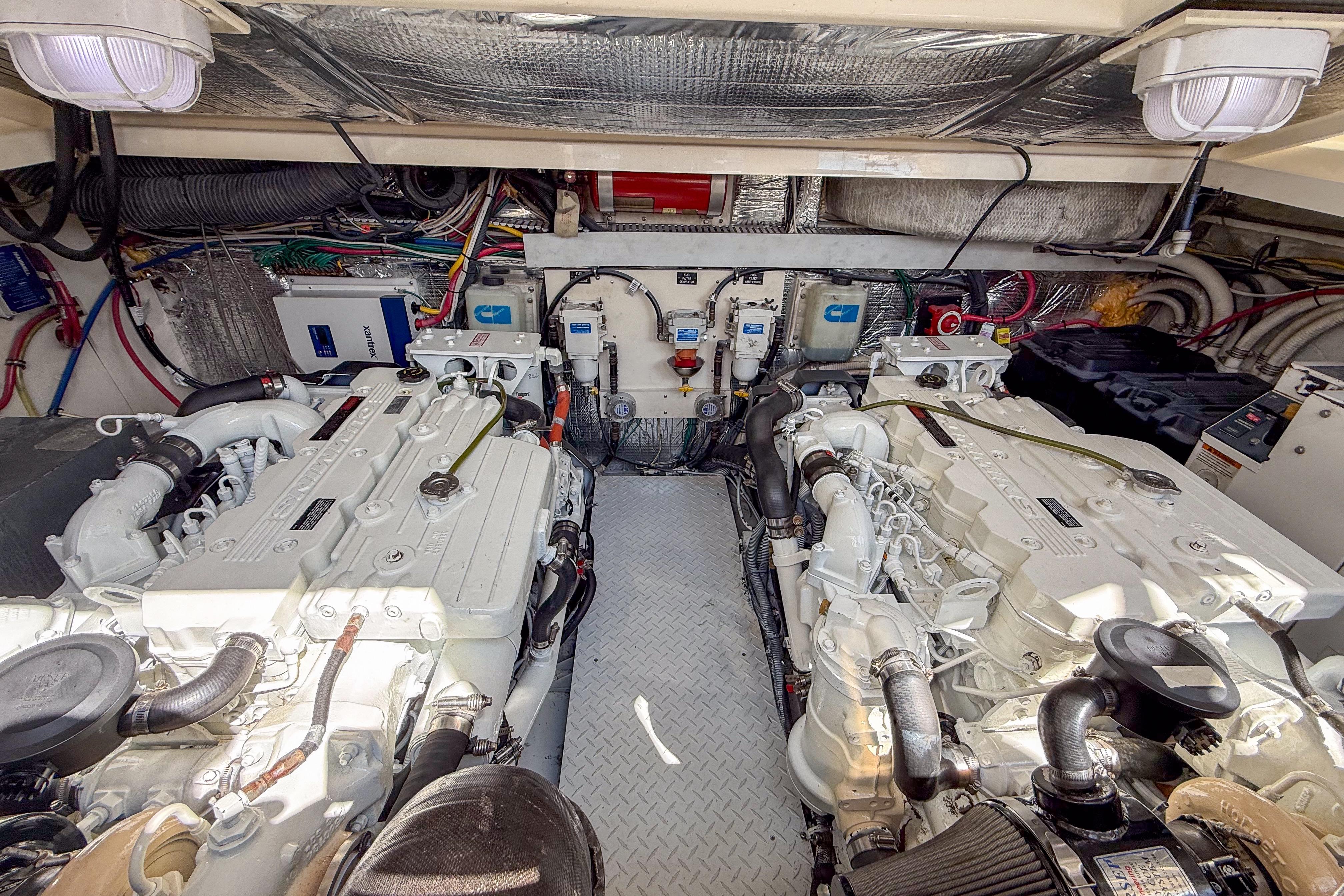 Engine room of 2005 Rampage 33 Express boat with dual engines and mechanical components.