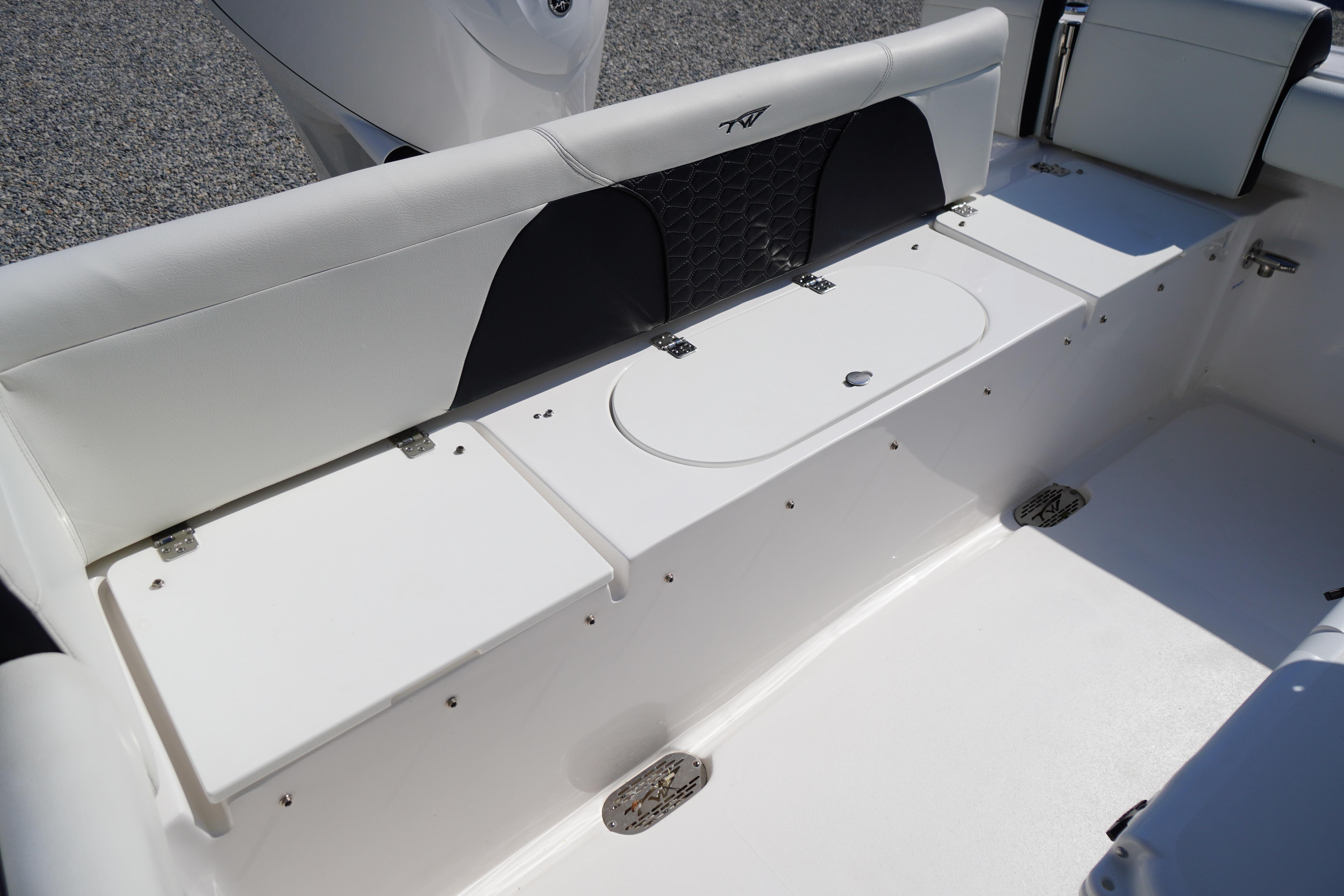 2025 Tidewater 232 SS boat interior with sleek seating and storage compartments.