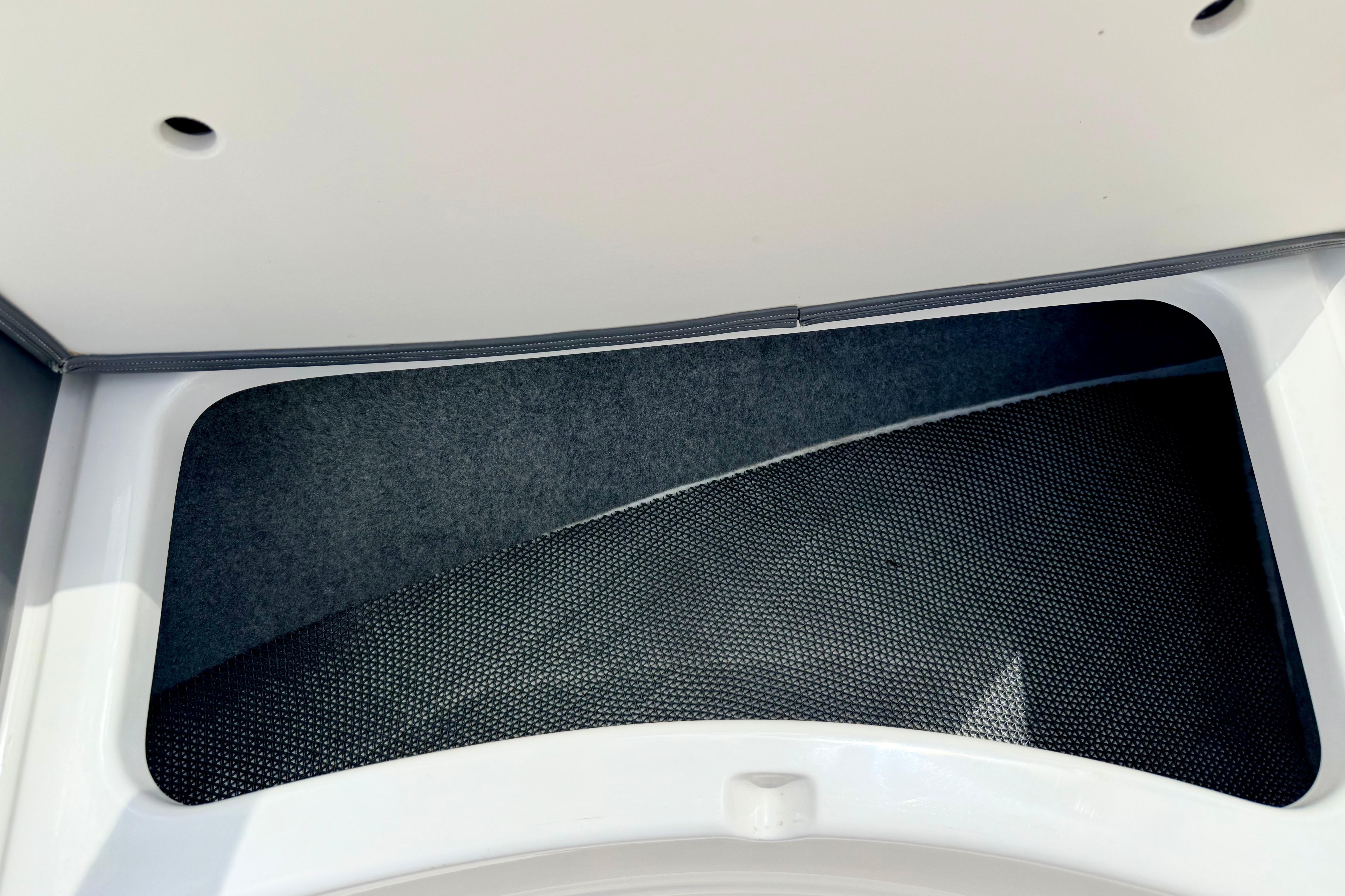 Storage compartment in 2015 Chaparral Sunesta 264 boat, featuring sleek interior design.