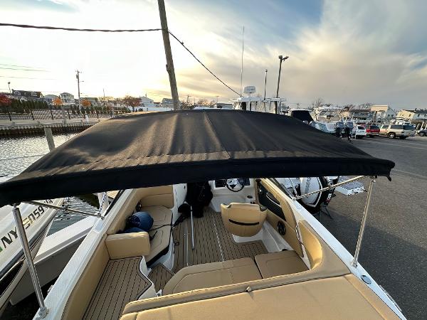 2021 Sea Ray SPX 190 boat with black canopy at the dock.