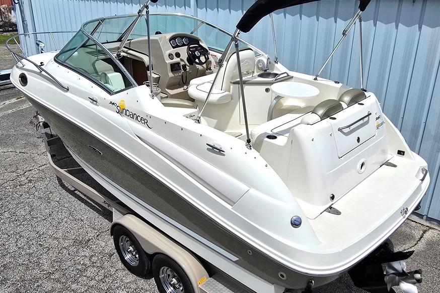 2006 Sea Ray 240 Sundancer boat on trailer, featuring sleek design and spacious cockpit.