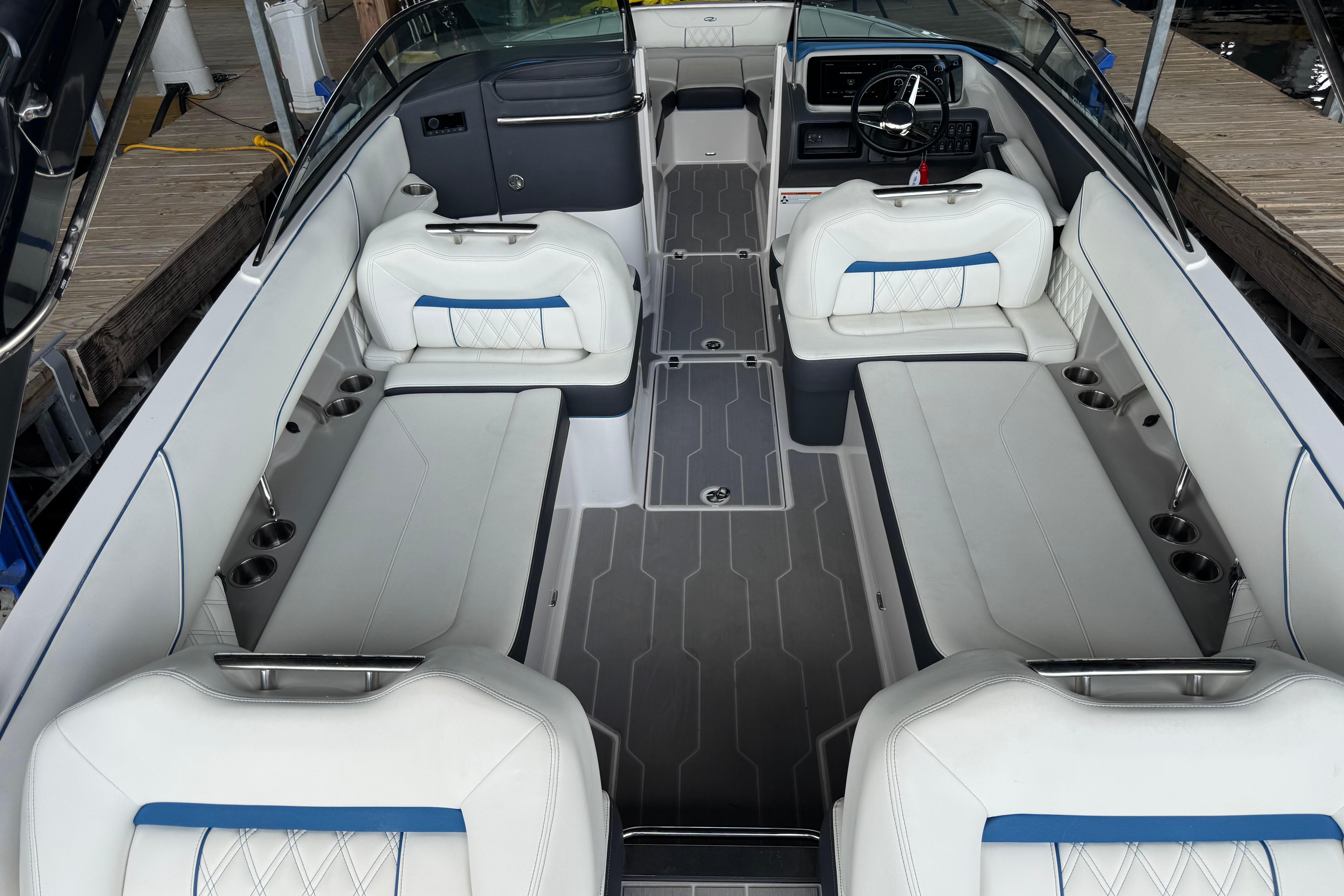 2022 Regal LS6 Surf boat interior with luxurious white seating and modern dashboard.