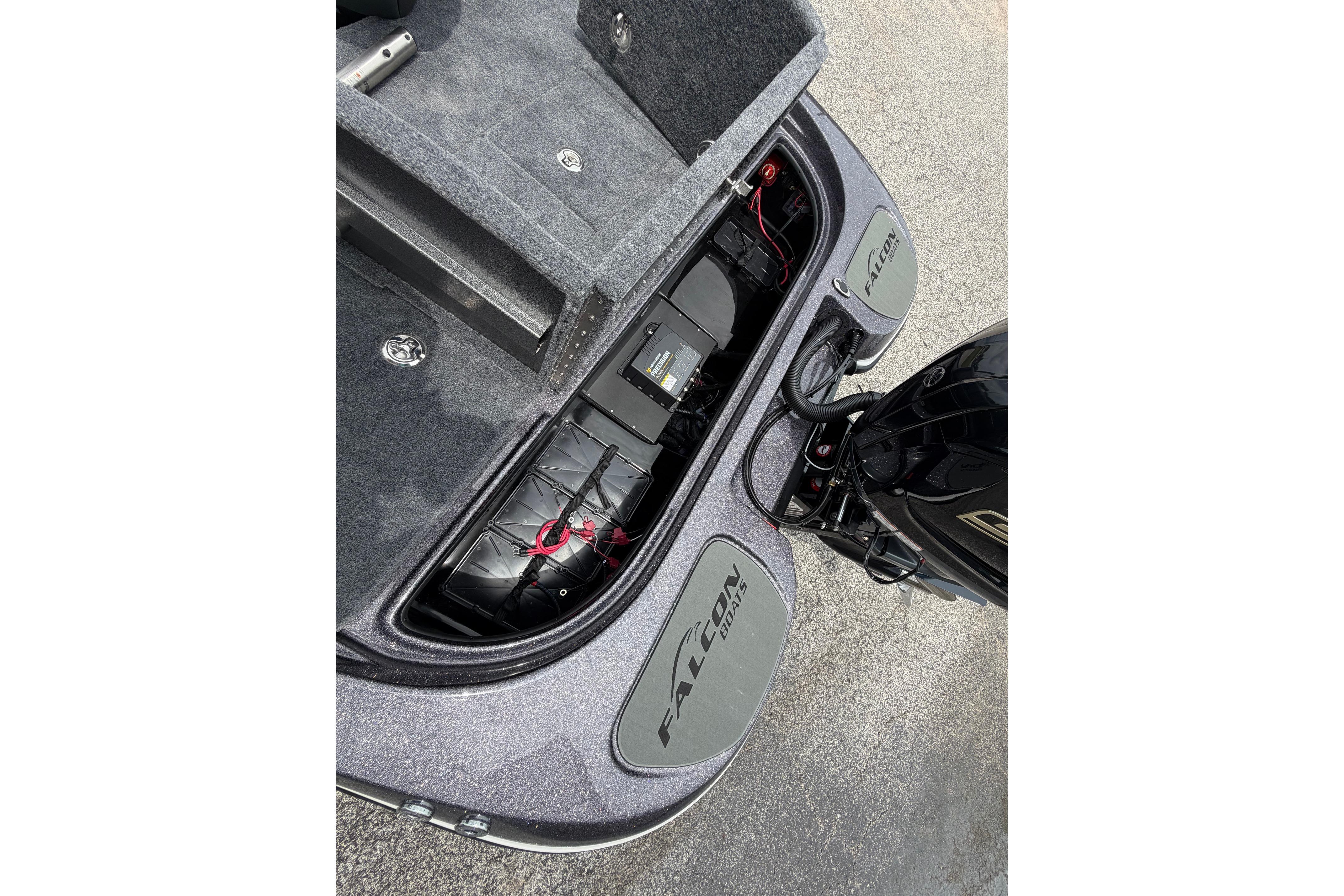 2027 Falcon Boats F215 rear compartment with engine and battery storage.