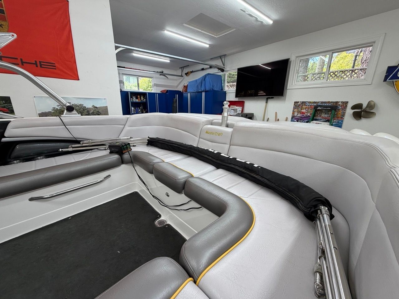 Interior of a 2006 MasterCraft X30 with white upholstery and a black floor.