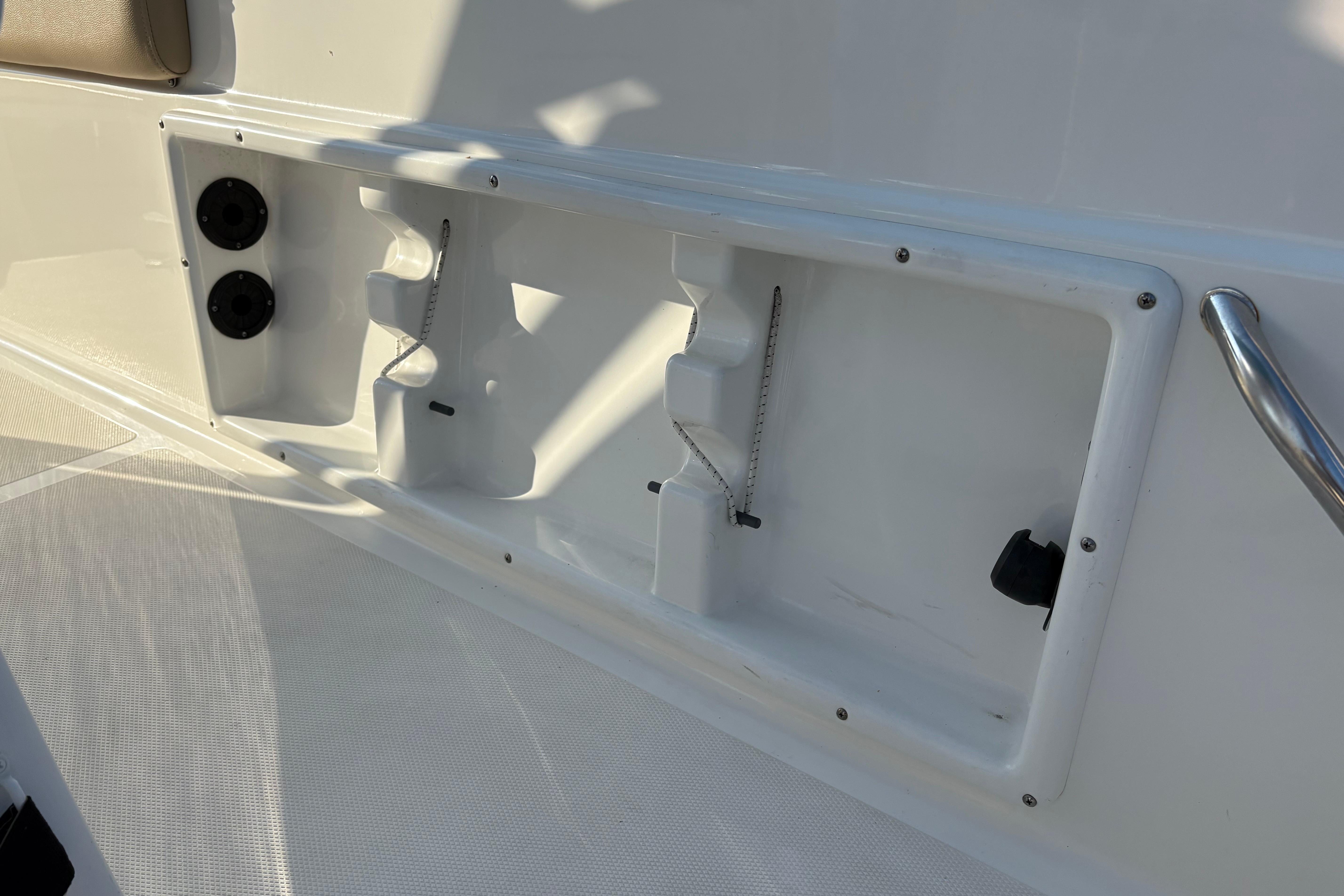 2019 NauticStar 231 Hybrid boat interior detail with storage compartments and fixtures.