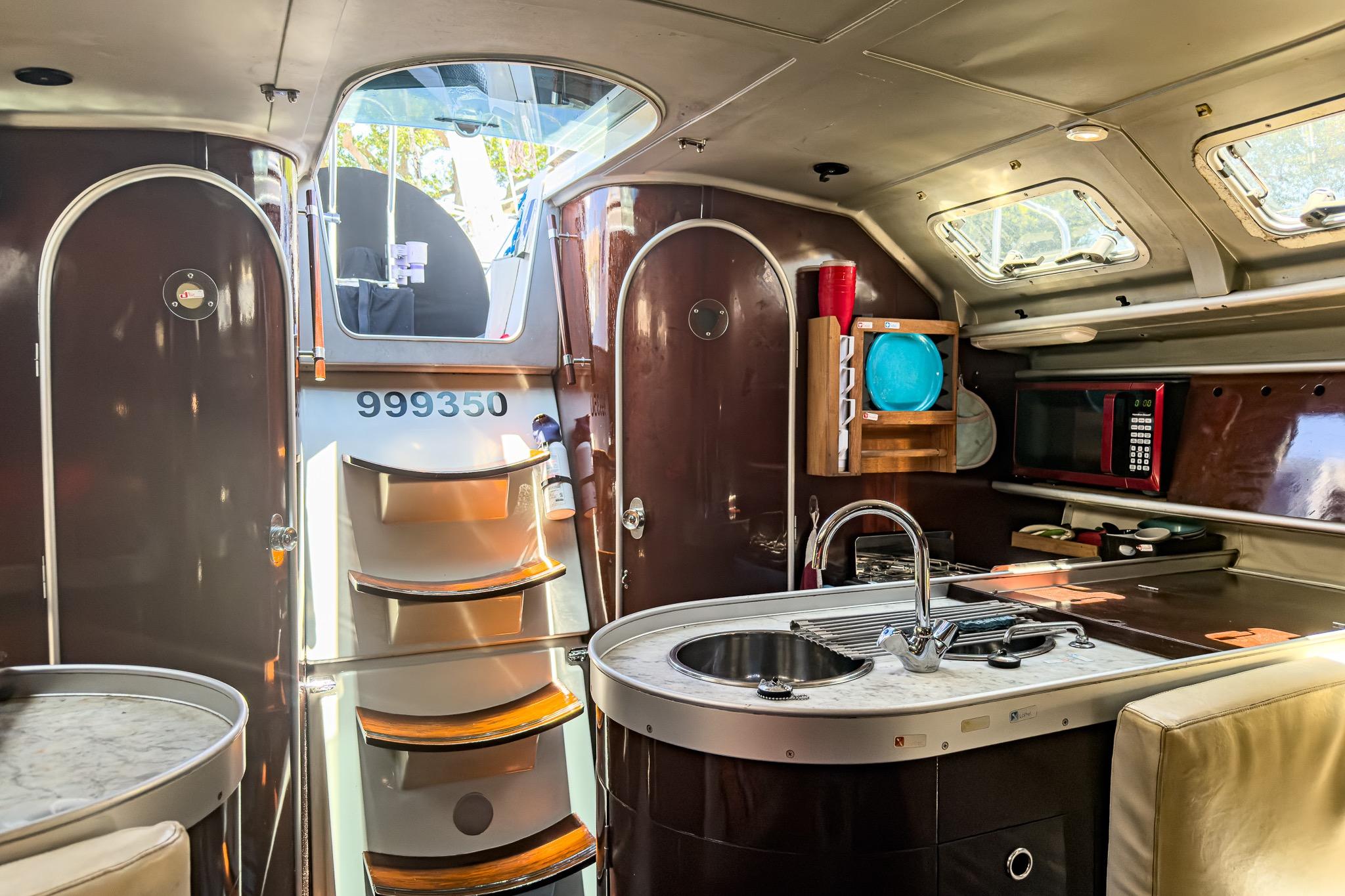 Interior of a 1993 Beneteau First 38 s5 sailboat with modern kitchen amenities.
