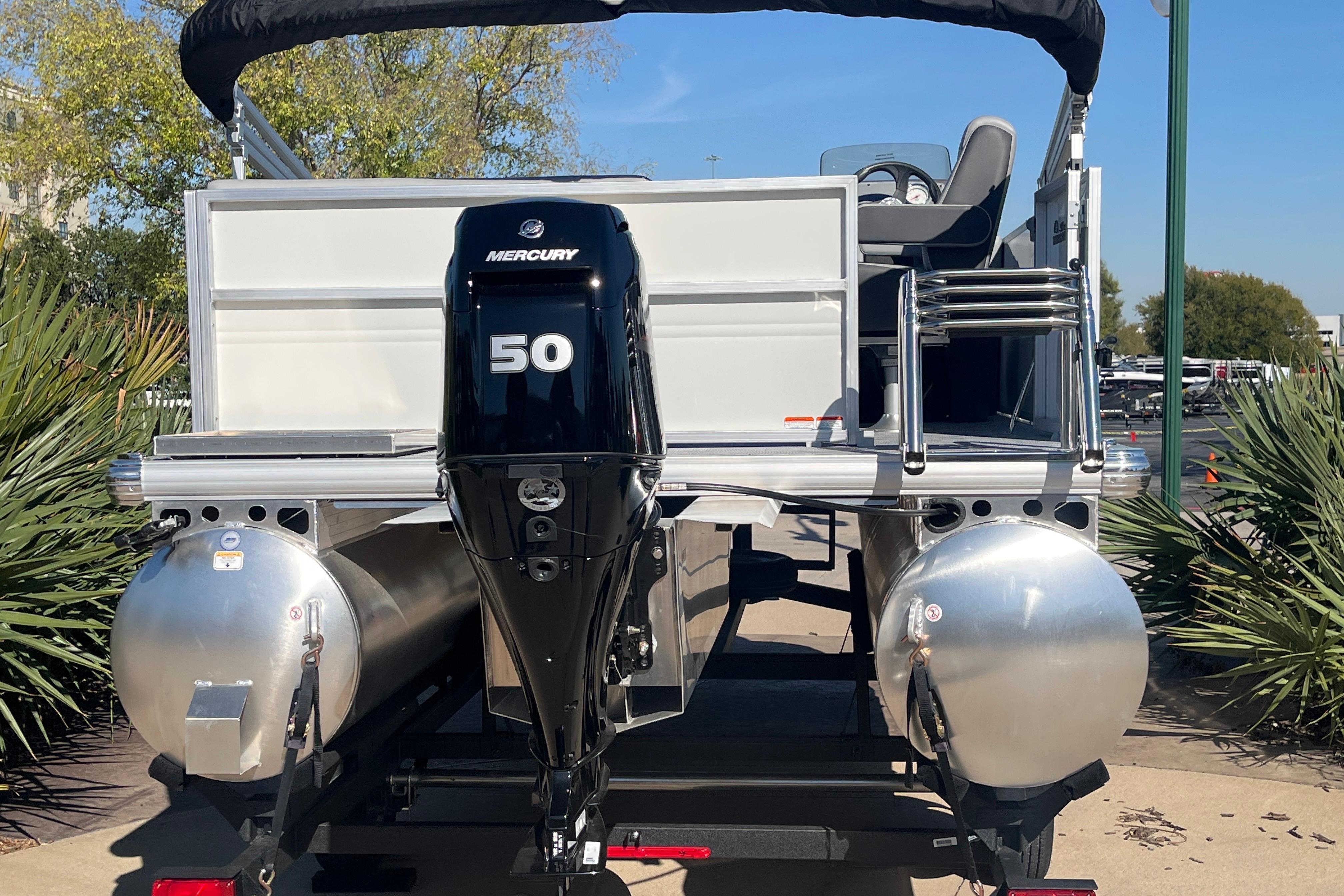 2026 Sun Tracker Party Barge 16 DLX with Mercury 50 engine, rear view.