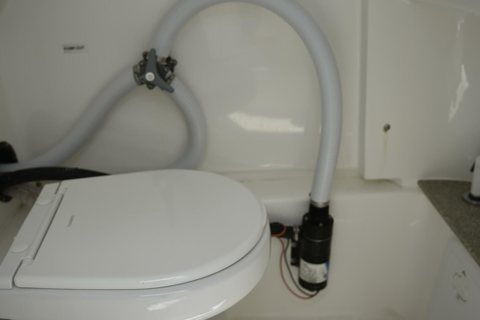 2023 Sea Pro 239 Deep V CC boat interior with marine toilet and plumbing.