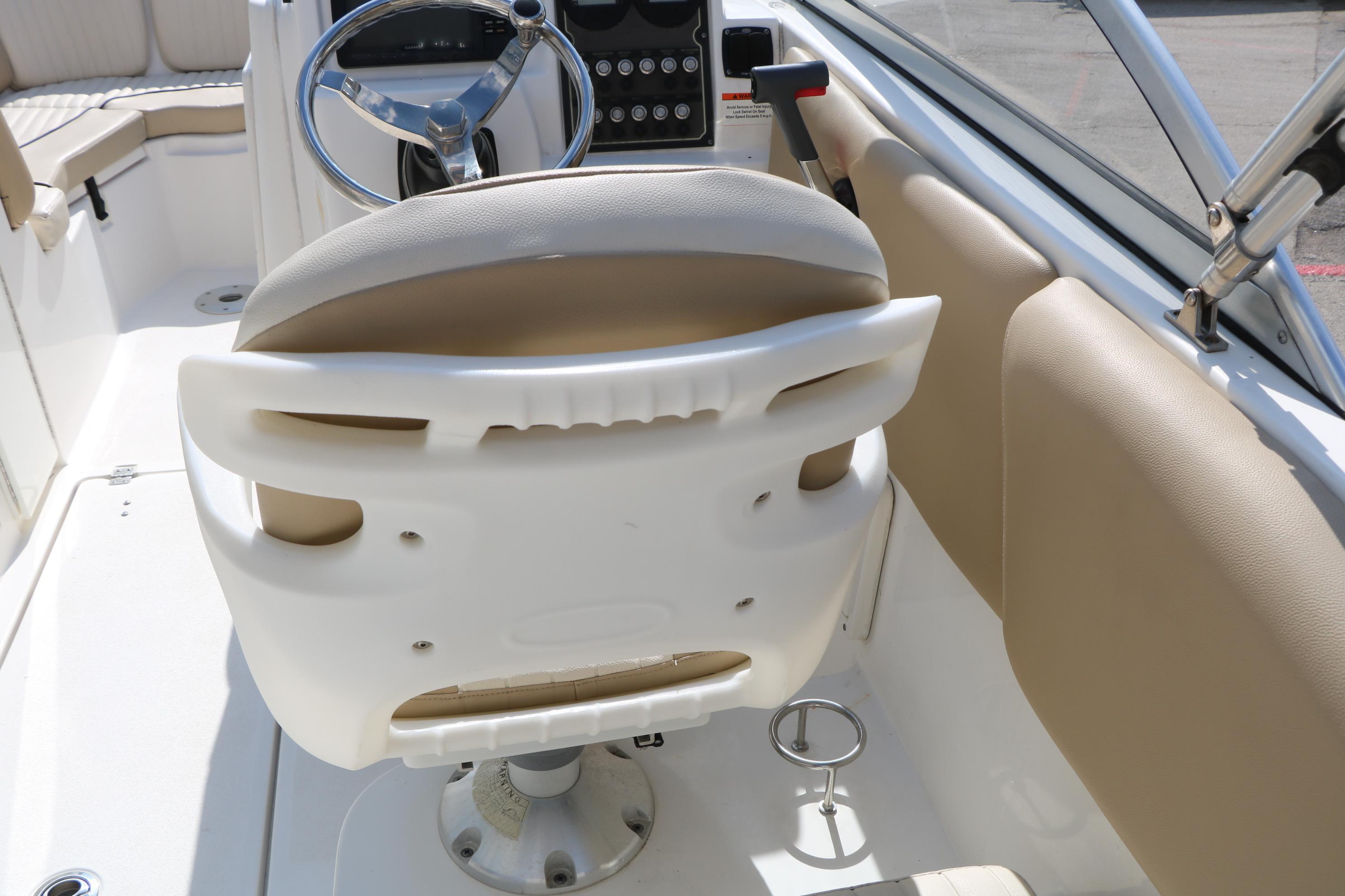 2017 Sea Fox 226 Traveler boat interior with steering wheel and beige seating.