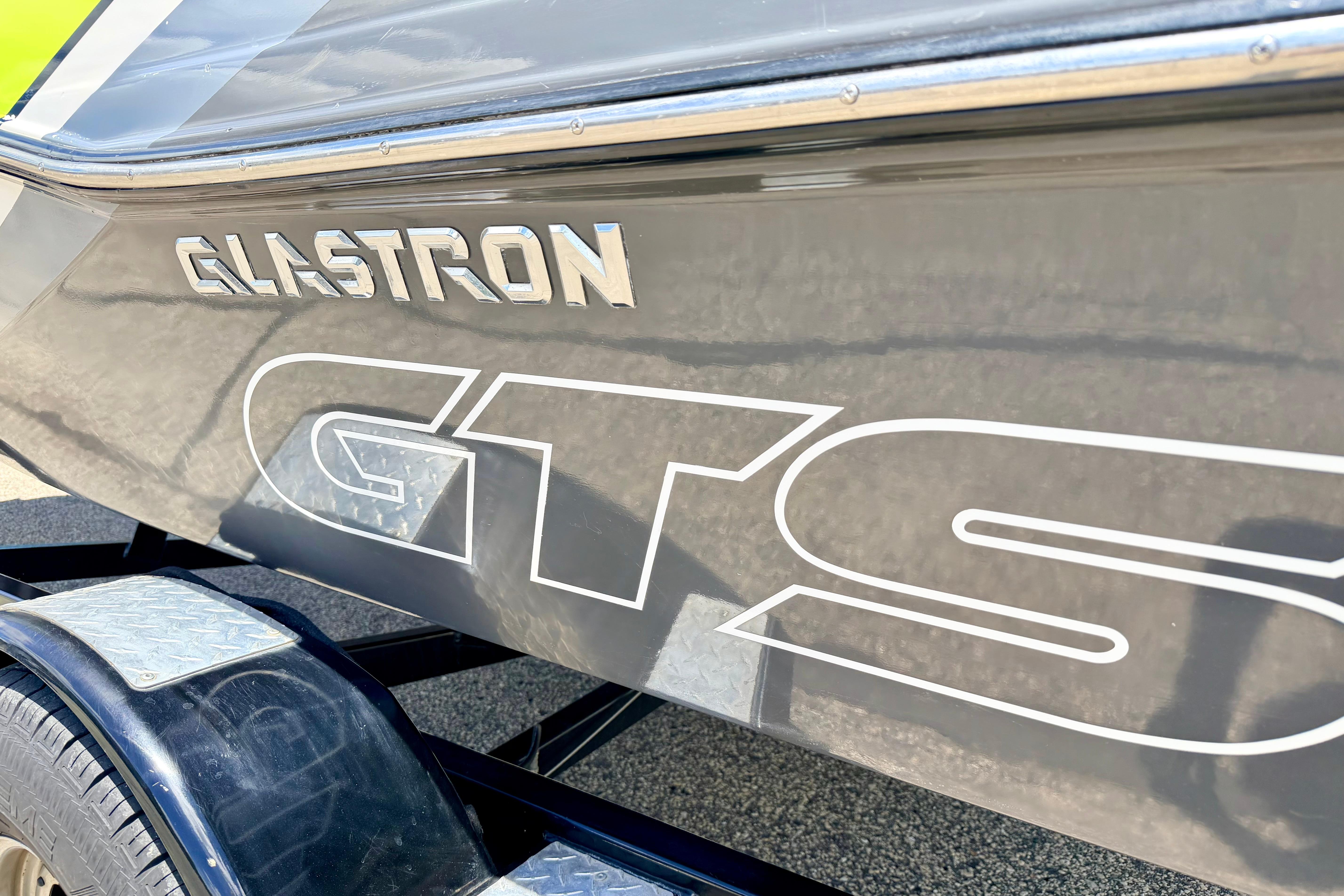 2018 Glastron GT 185 boat side view with logo and trailer detail.