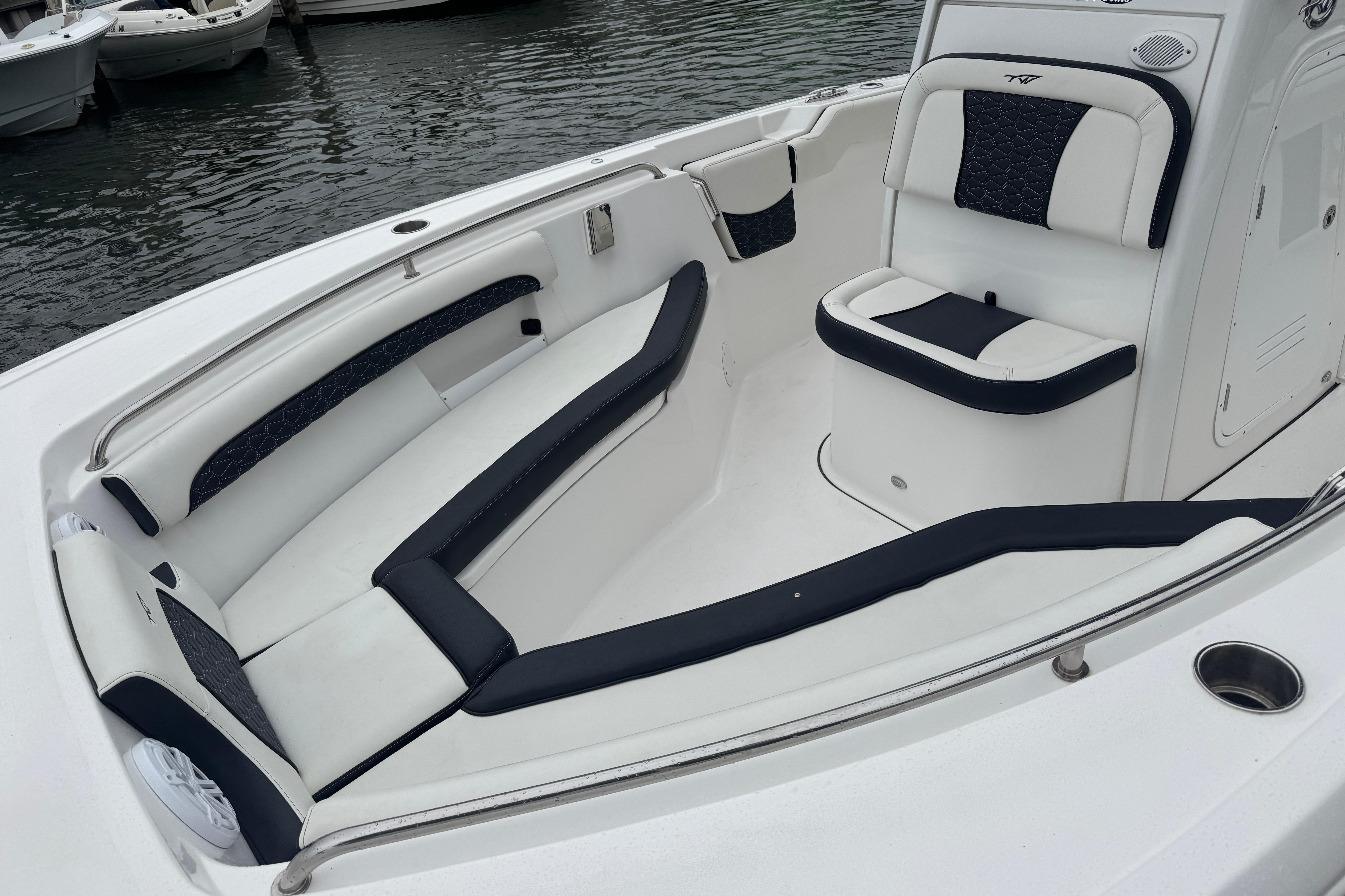 2025 Tidewater 232 LXF boat interior with sleek white and black seating.
