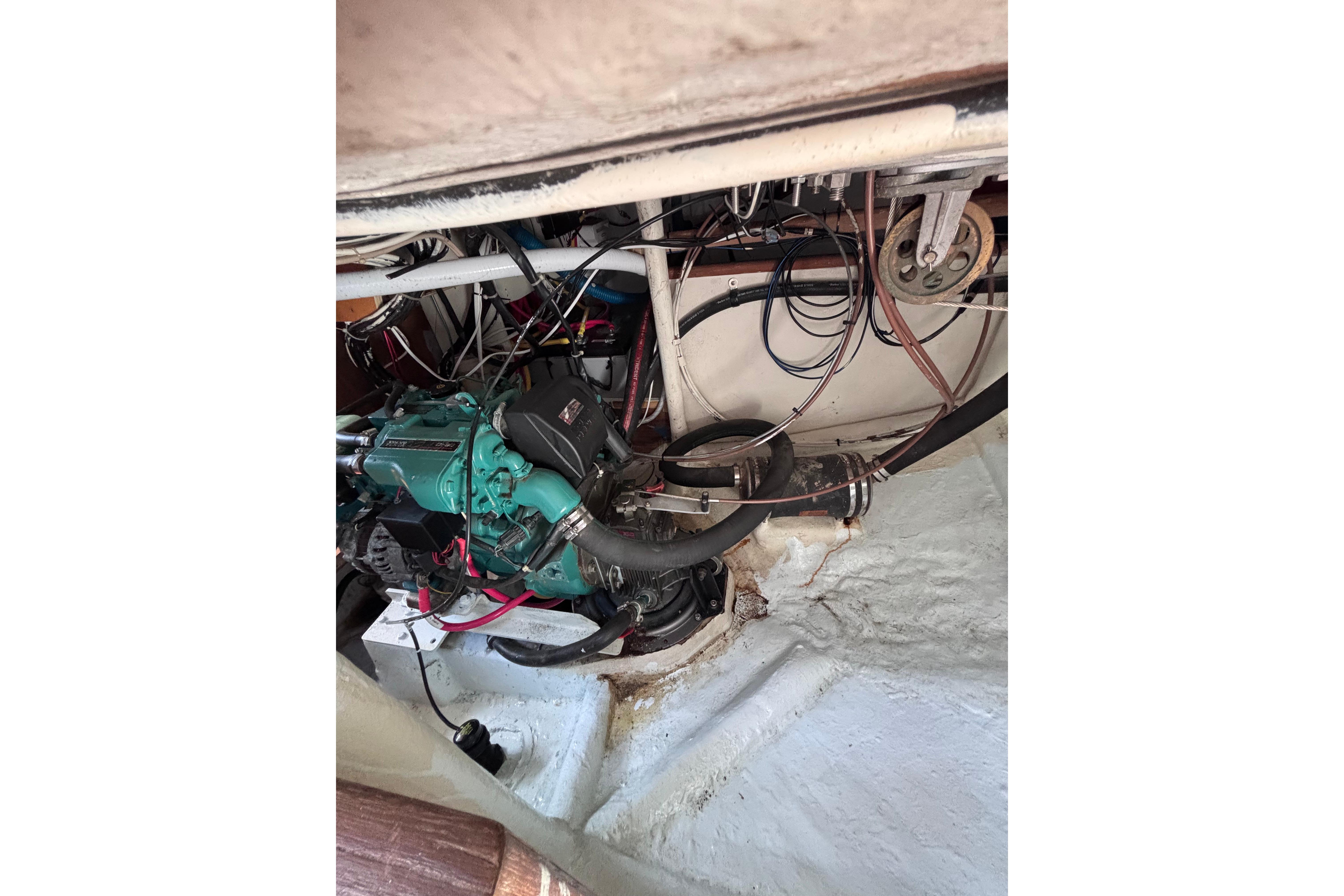 Engine compartment of a 1978 Swift 33 boat, showcasing wiring and mechanical components.