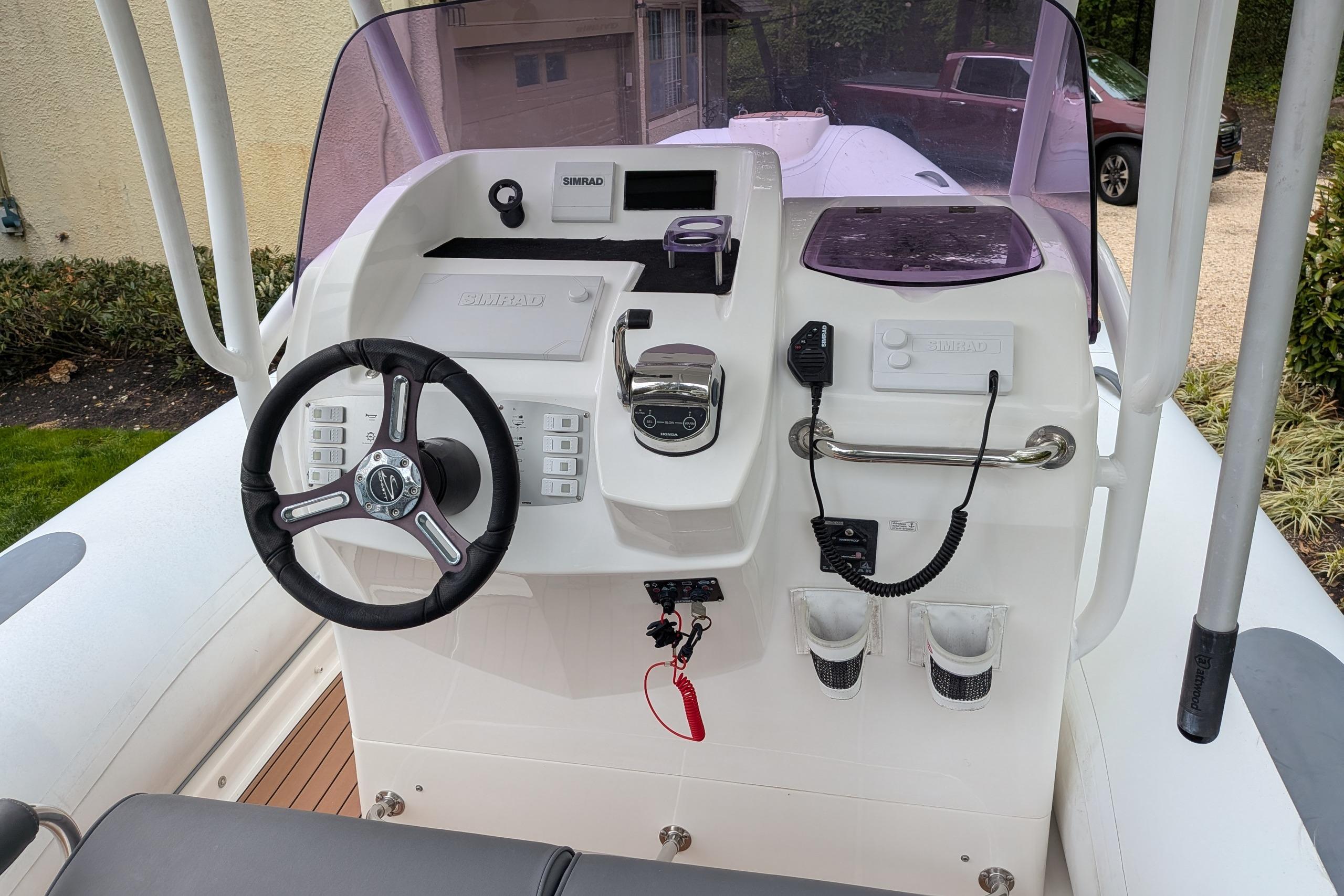 2016 Brig E780 boat dashboard with steering wheel, controls, and navigation equipment.