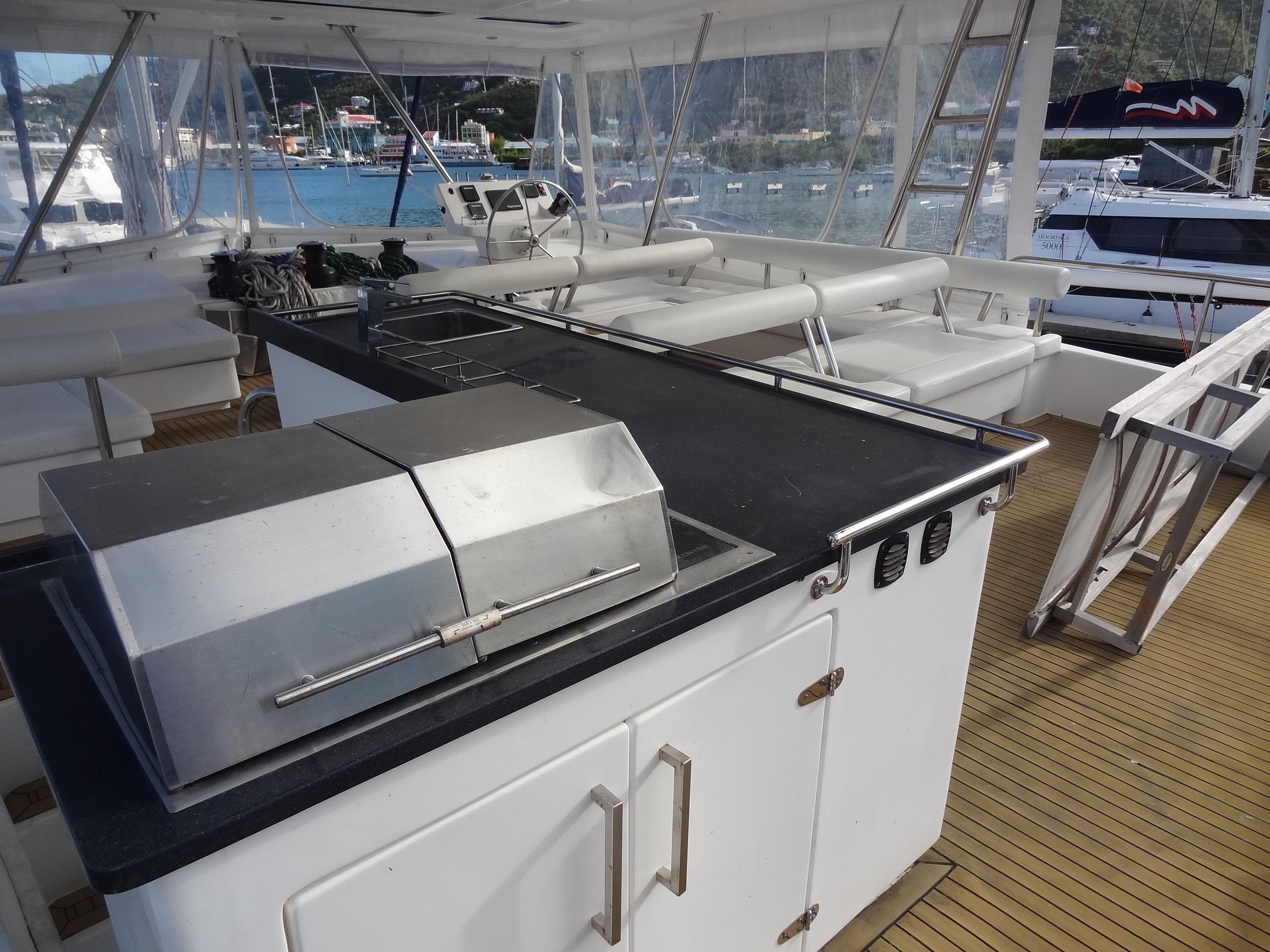 Outdoor kitchen and seating area on a 2014 Leopard 58 yacht.