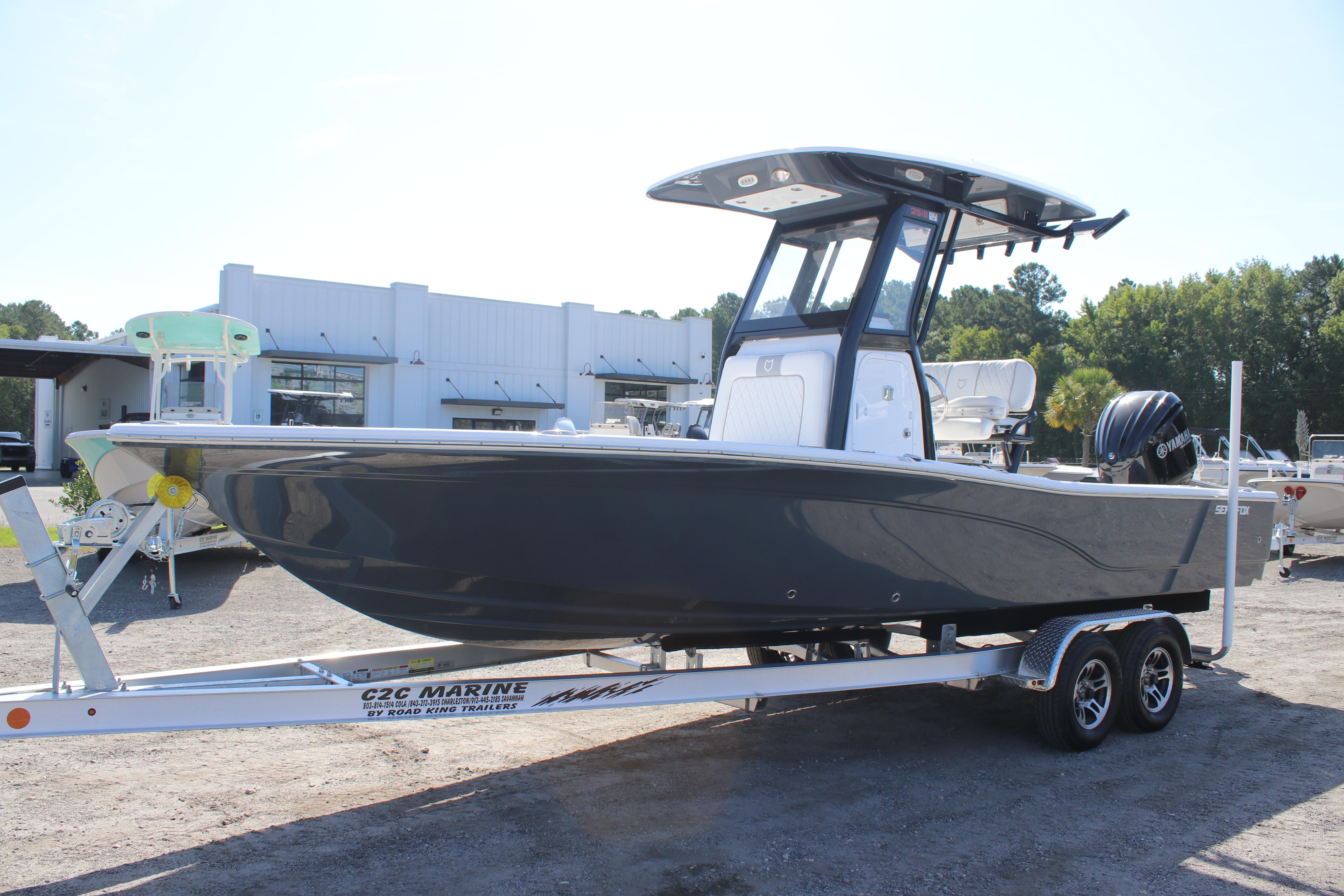 2025 Sea Fox 251 Bay Fox boat on trailer at dealership.